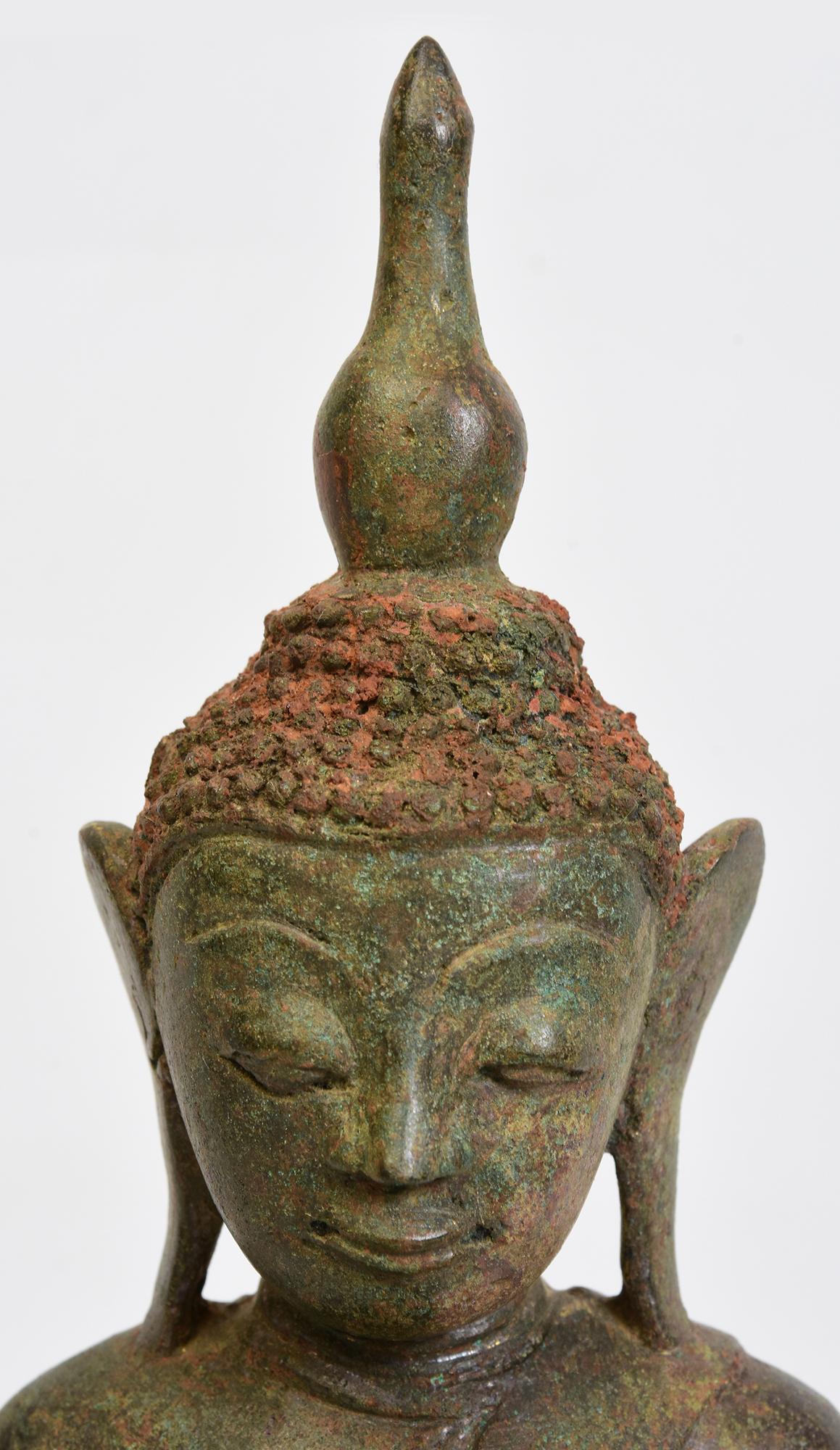 Antique Burmese bronze Buddha sitting in Mara Vijaya (calling the earth to witness) posture on double lotus base.

Age: Burma, Ava Period, 16th Century
Size: Height 32.5 C.M. / Width 16.2 C.M. / Depth 10.4 C.M.
Condition: Some expected degradation