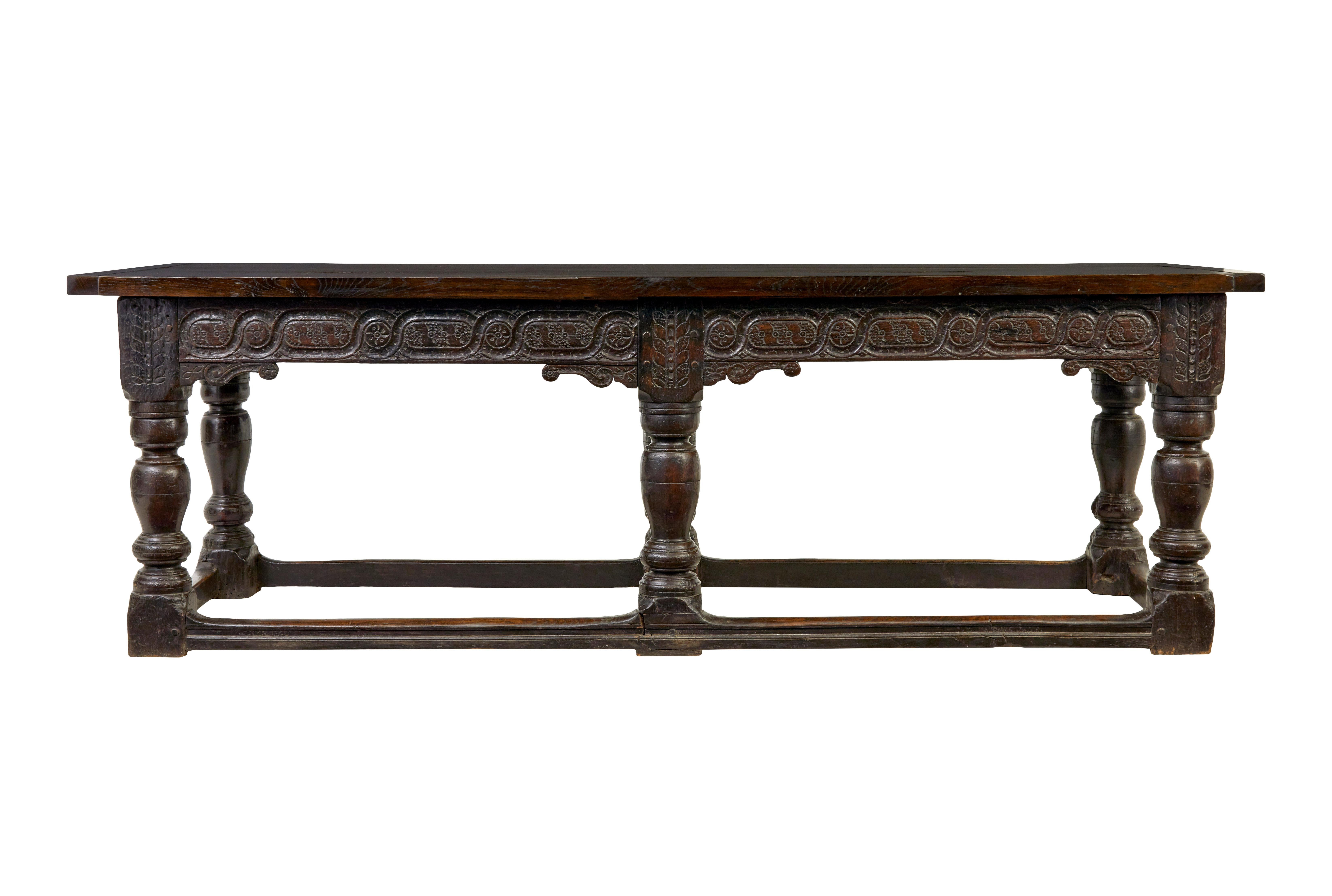 16th century and later Elizabethan solid oak refectory table circa 1590.

We are pleased to offer this beautiful table, with elizabethan period base and later 3 plank oak top.  Carved frieze which goes round the front and sides and plain oak the the