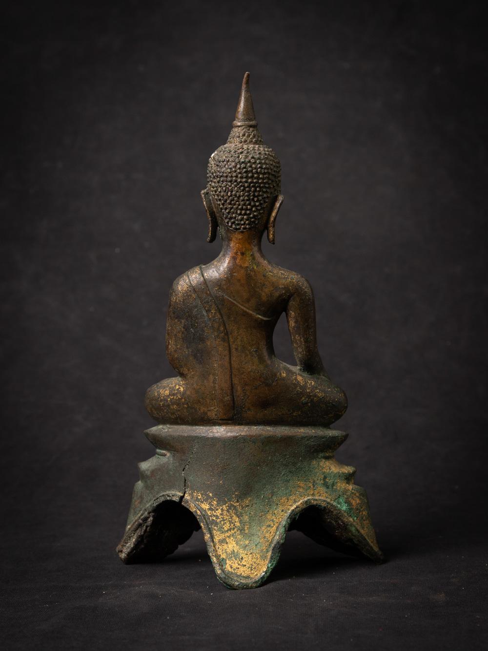 The antique bronze Thai Buddha statue is a captivating and historically significant artifact. Crafted from bronze and bearing traces of 24-karat gold gilding, this statue stands at 23.2 cm in height and measures 13.4 cm in width and 6.9 cm in depth.