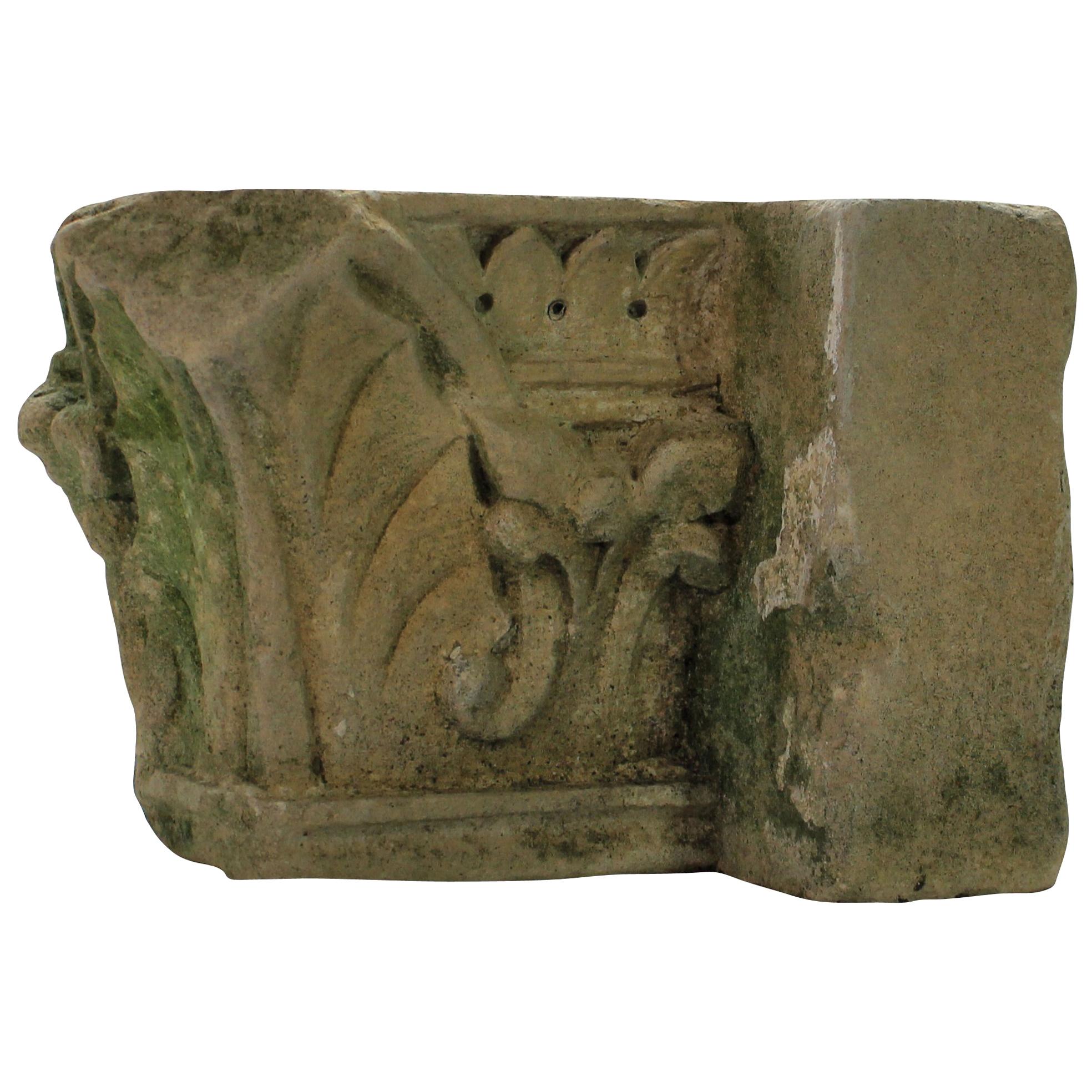 An English classically carved limestone architectural fragment depicting acanthus with traces of paint.
   