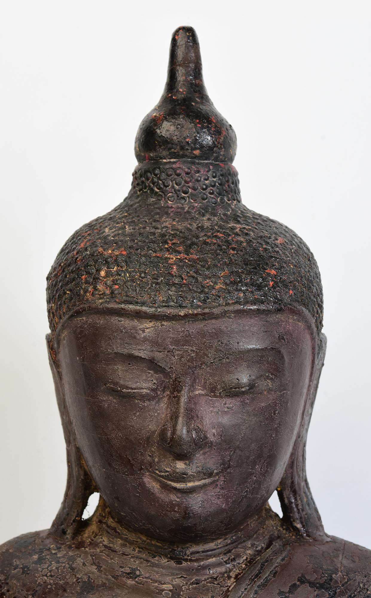 Burmese wooden Buddha sitting in Mara Vijaya (calling the earth to witness) posture on a base.

Age: Burma, Ava Period, 16th Century
Size: Height 57.4 C.M. / Width 30 C.M. / Depth 13.5 C.M.
Condition: Nice condition overall (some expected