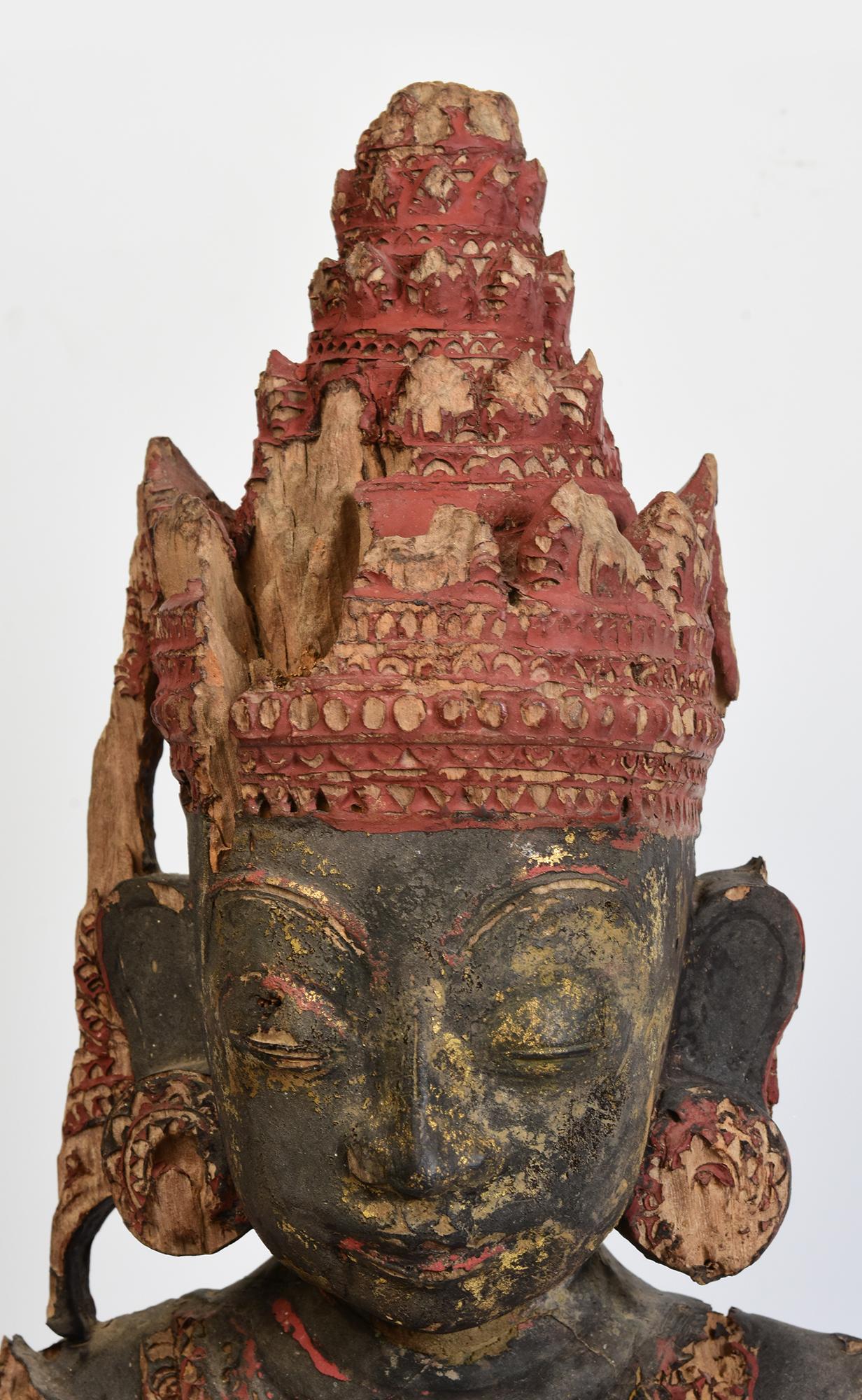 Rare antique Burmese wooden seated crowned Buddha, or sometimes known as 'King Buddha', wearing diadem-crowns and ornaments of king instead of ordinary monk's robes.

Crowned Buddha represents the Buddha's role as a universal sovereign. 

Age: