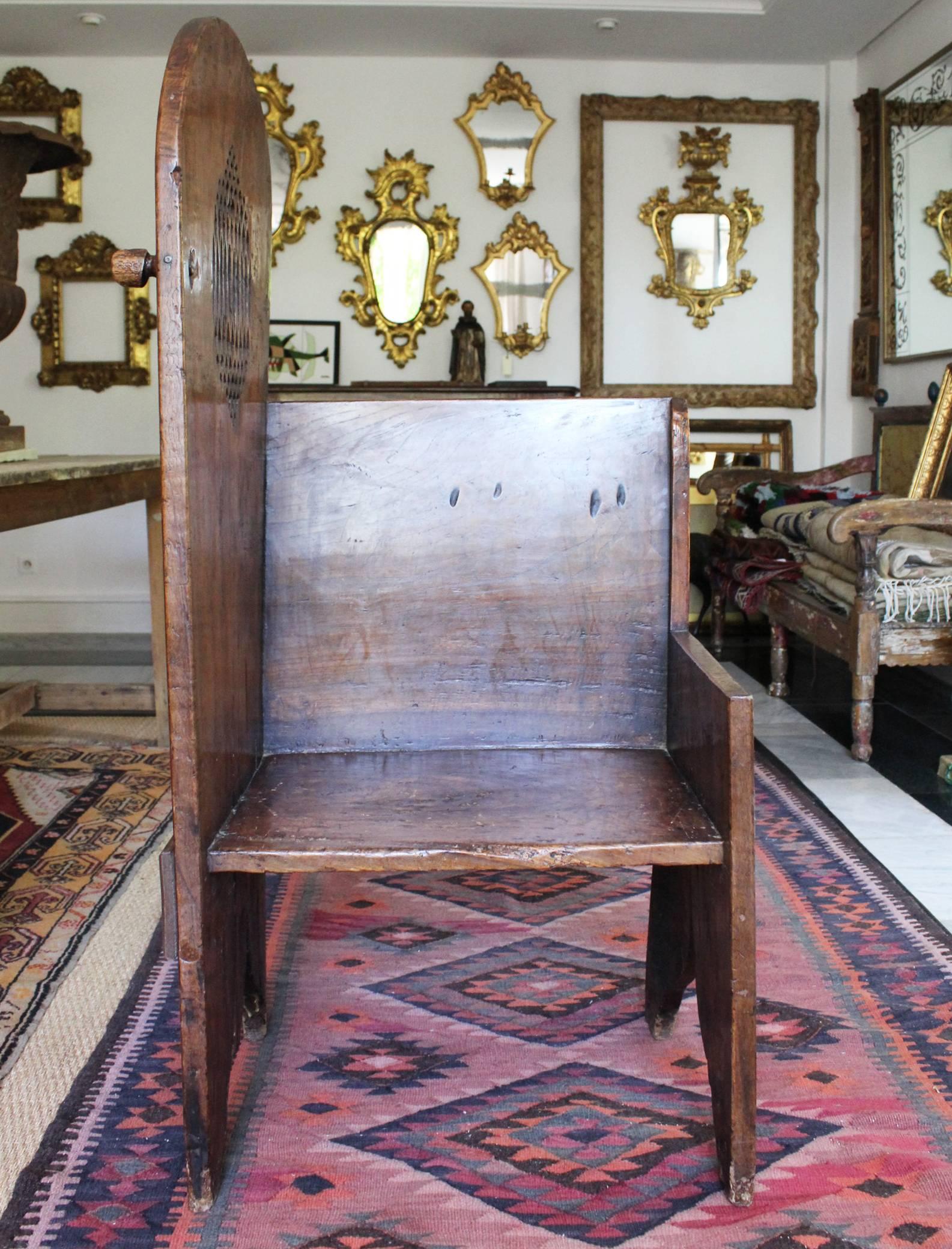 16th century Belgian Gothic oak wood confessional with a carved side opening hiding the faithful's faces.
 