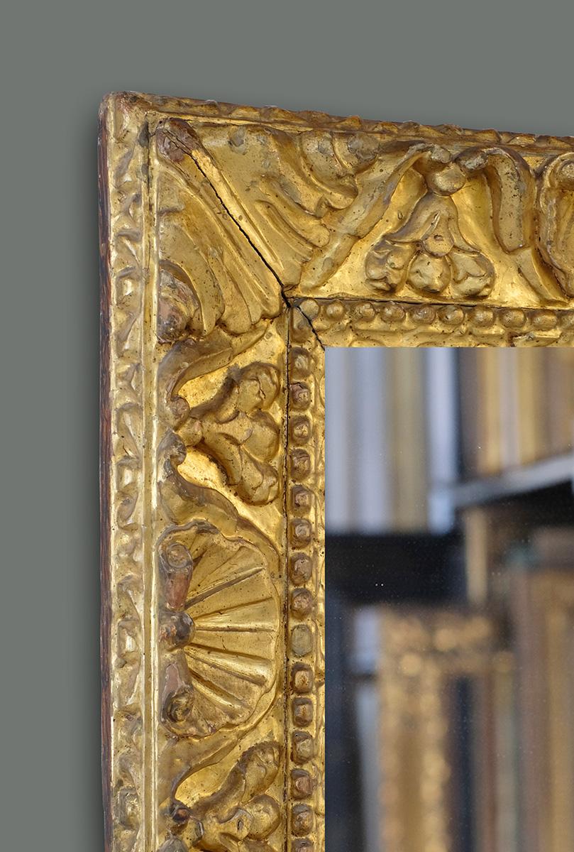 This is another one of the jewels from our collection, an exceptional hand carved late 16th century Venetian (Italian) Renaissance frame. It has carved scallop shells alternating with triple buds linked by foliate scrolls and corner acanthus leaves,