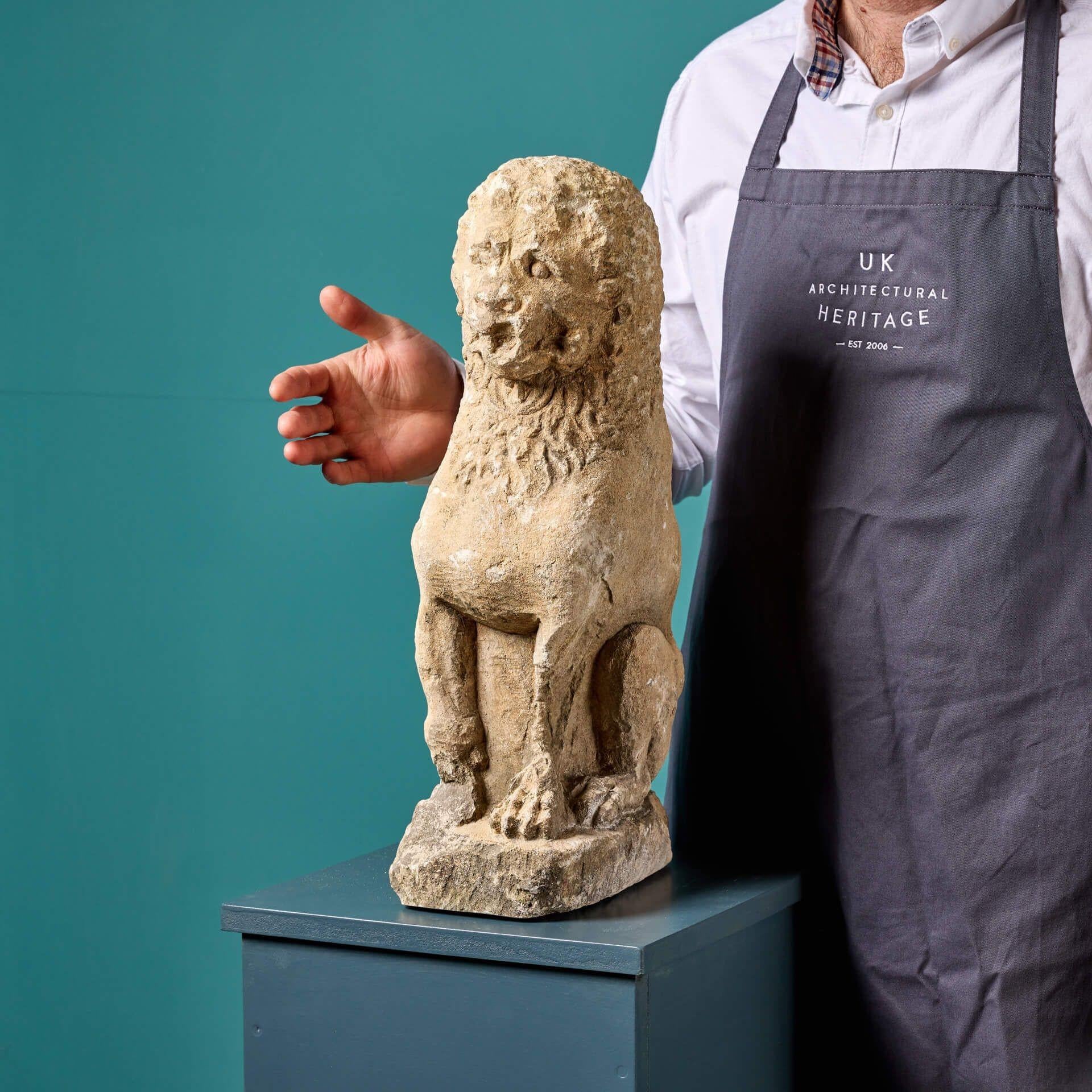 An English hand carved limestone lion statue possibly dating from as early as the 16th century. Made at the hand of a talented artisan, the limestone is detailed with tooling and chisel marks made by the maker throughout, depicting a small lion in a
