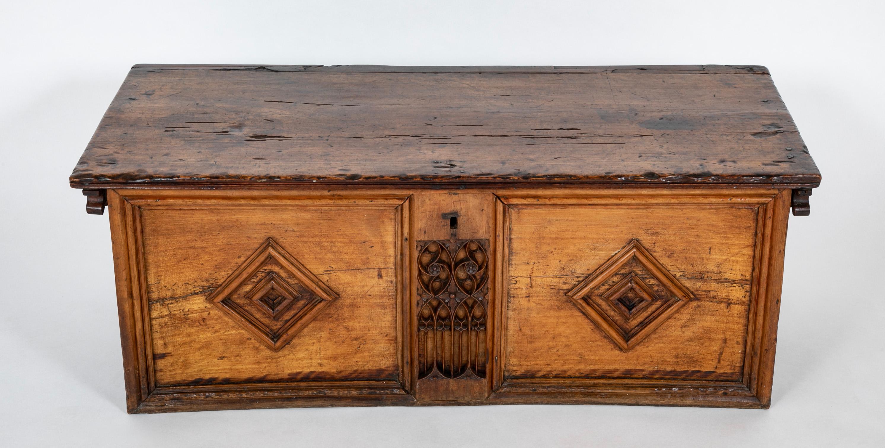 A wonderful early walnut chest, French 16th century, with a central panel of Gothic tracery. The only other decoration are simple raised molding square diamonds one the front and sides. I love the simplicity of this piece, showing the transition