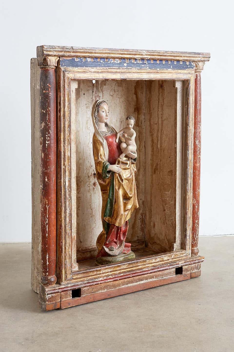 Extraordinary polychromed 16th century Madonna and child from a French monastery. Solid carved wooden Santos statue featuring gilded flowing robe and polychrome finish. The Madonna or Virgin Mary has an exceptionally beautiful face and rich patina.