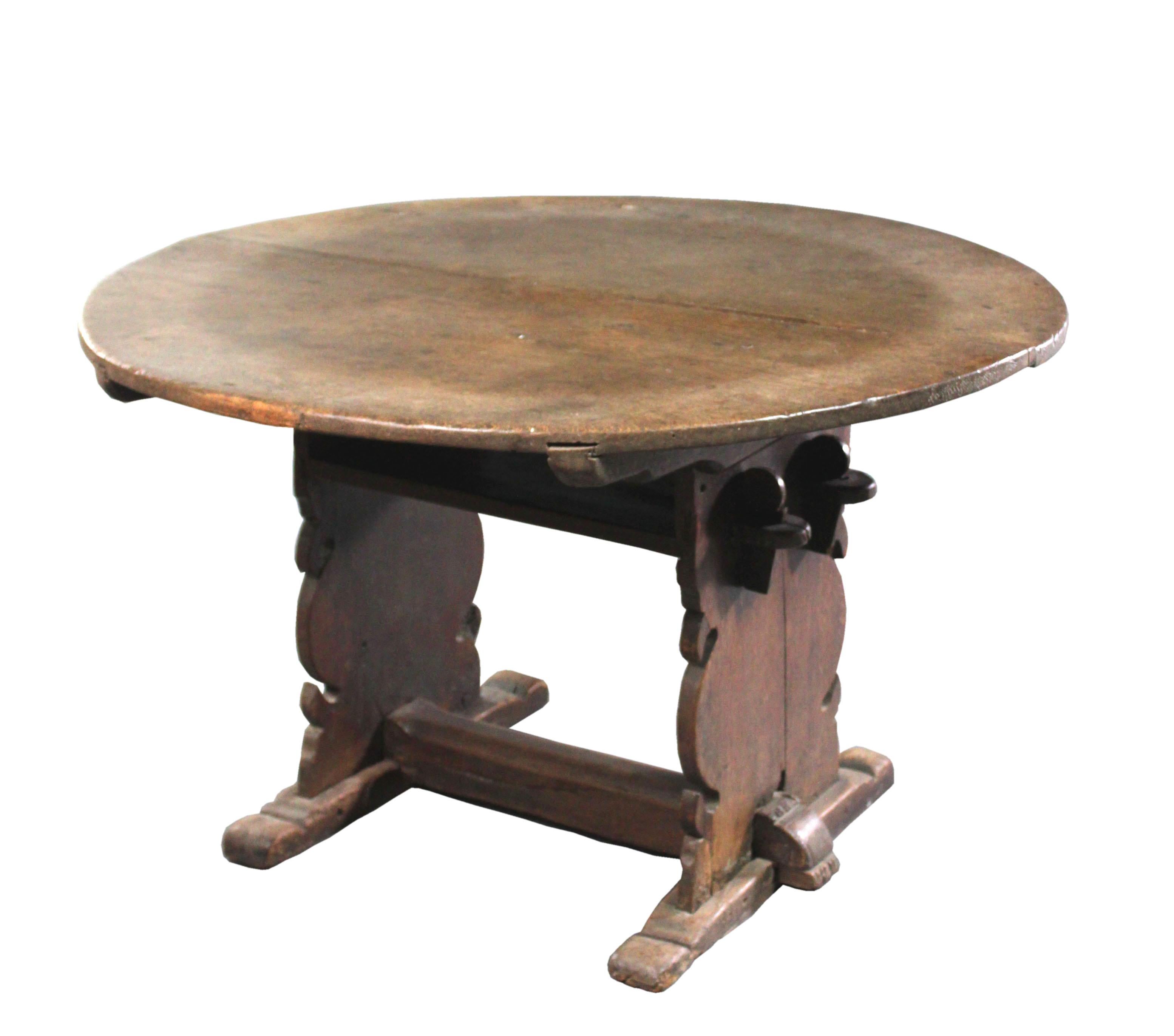 16th Century German oak monk's bench / centre table
Rare 16th Century German oak monk's bench / centre table, the near circular twin boarded top with underside locators pegged to shaped trestle ends; high boarded undershelf becomes a seat; sledge