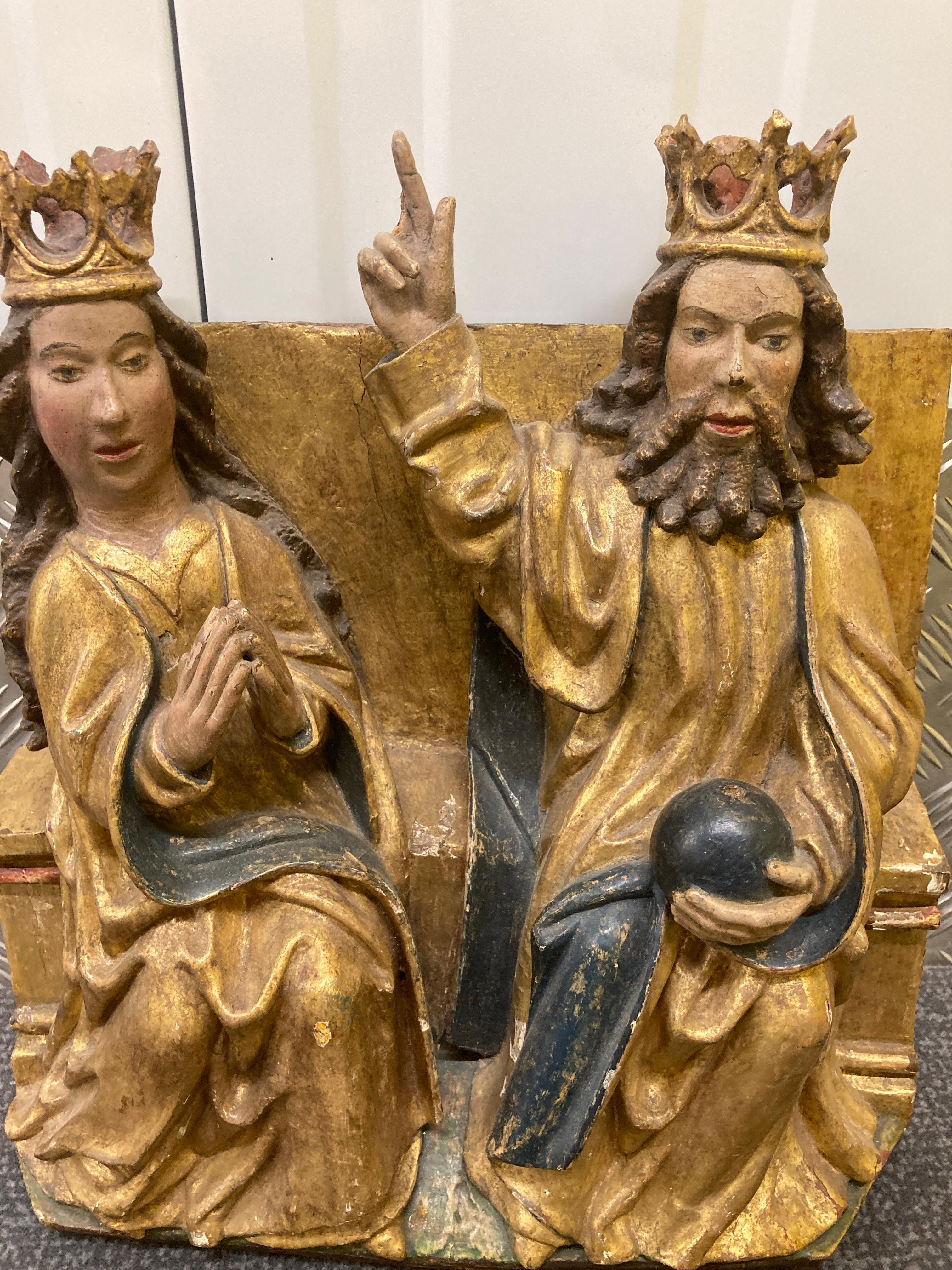 A 16th Century Giltwood and Polychromed Carved Group depicting God and Mary seated on a plinth.