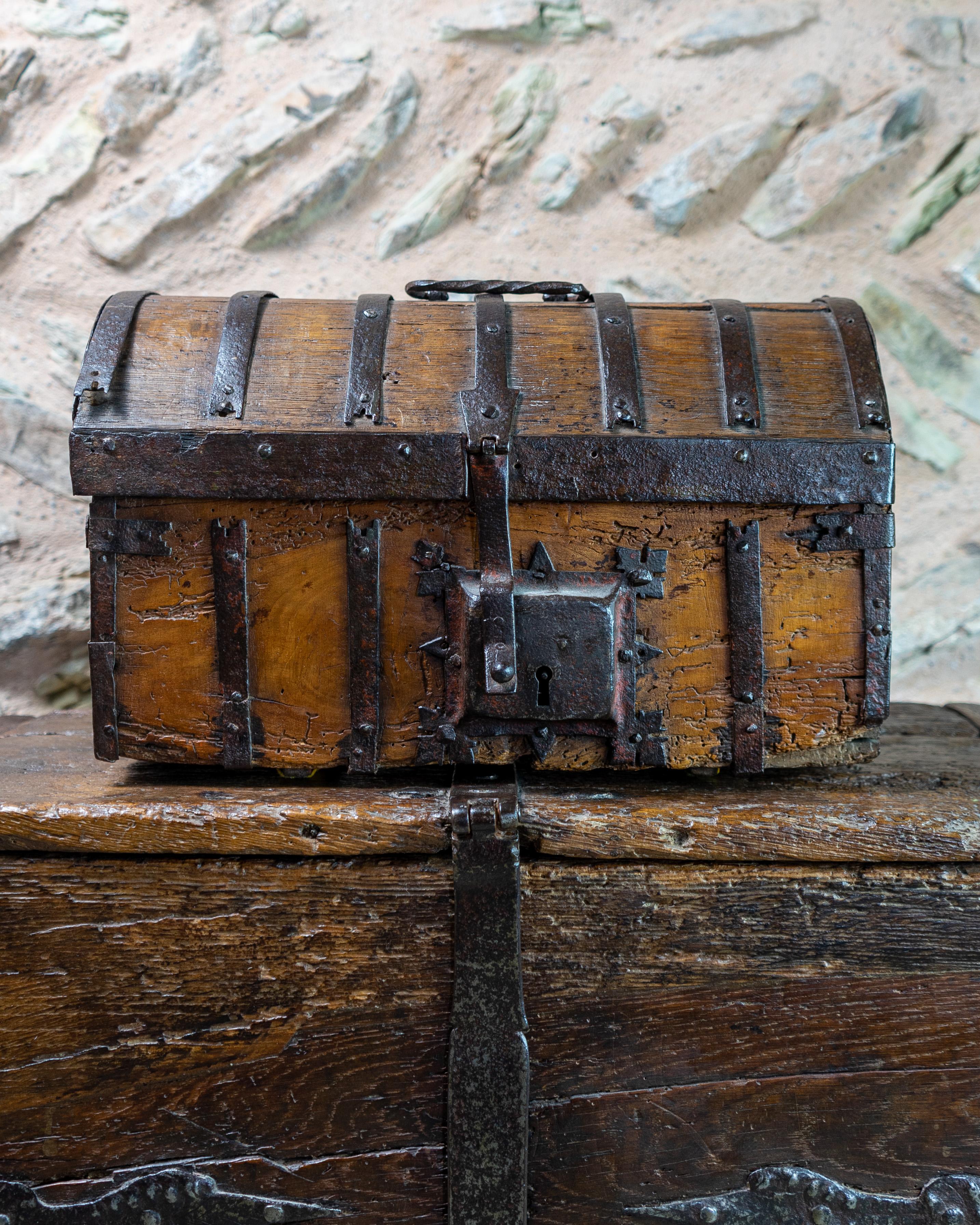 16th century, Late Gothic, iron bound casket, French, Circa 1500-1540

Rectangular casket with round-arched lid, with a twisted wrought iron handle on the lid, and a hasp and lock. The casket is bound & strengthened with iron showing traces of