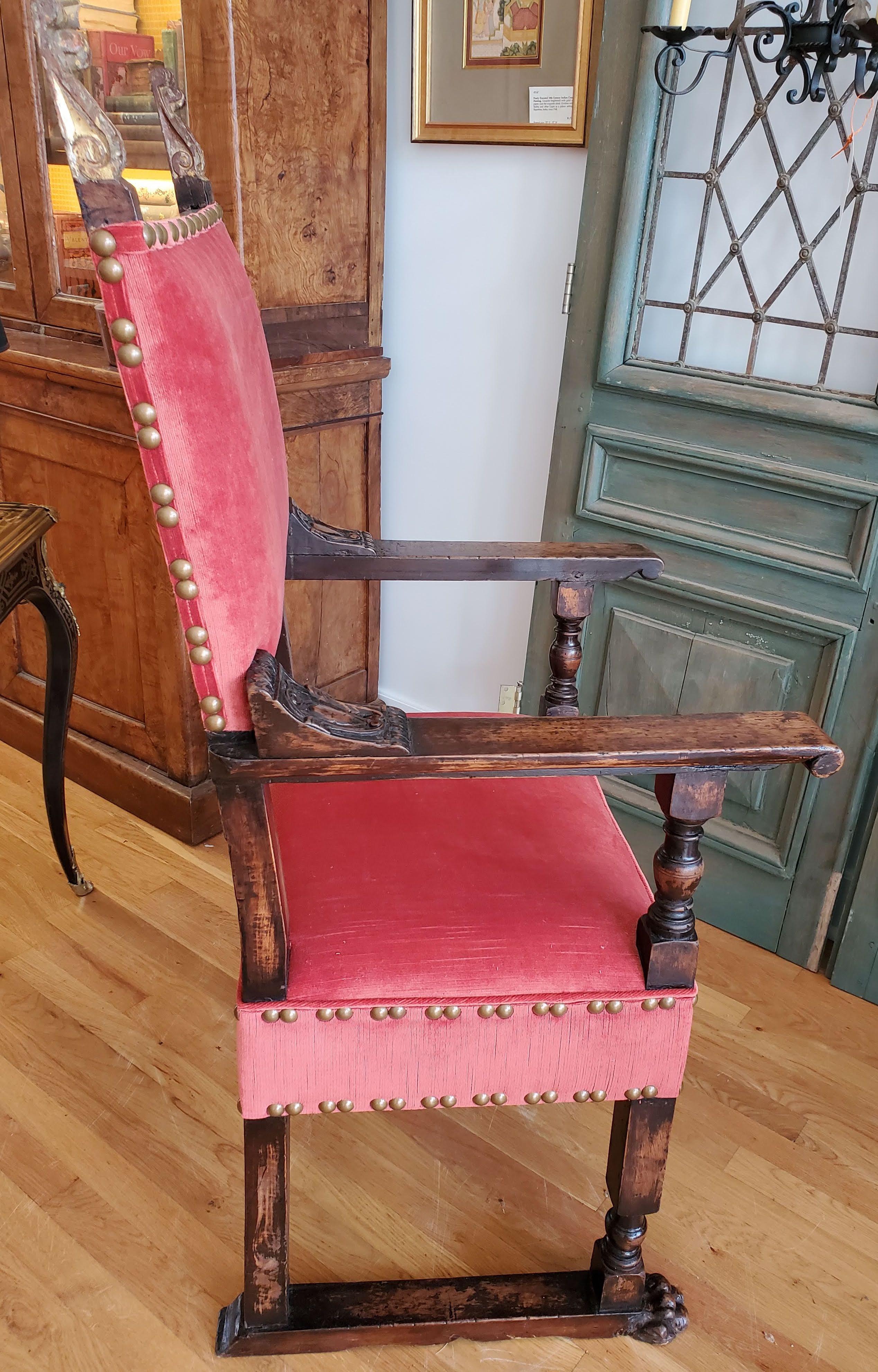 This is an extremely rare 16th century Italian armchair from the late Italian Renaissance period. Made of Circassian walnut with a deep patination and rich deep color. Decorative posts with carved acanthus leaves retaining the original gilding over