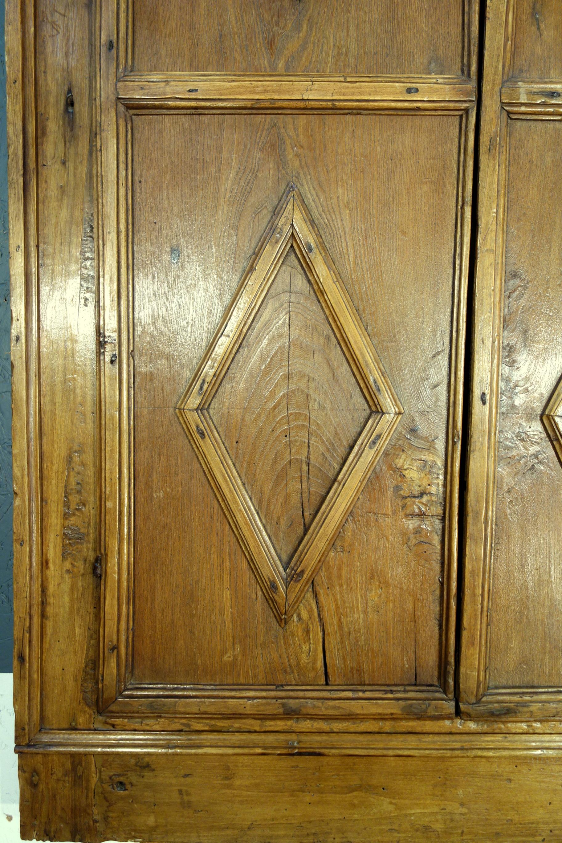 16th Century Italian Tuscan Old Chestnut 2 Door Stipo with Losanghe.  
Interesting architectural element composed of 2 framed and trimmed doors of single slabs of very old chestnut. Decorated with the typical Tuscan motif of the diamond geometric