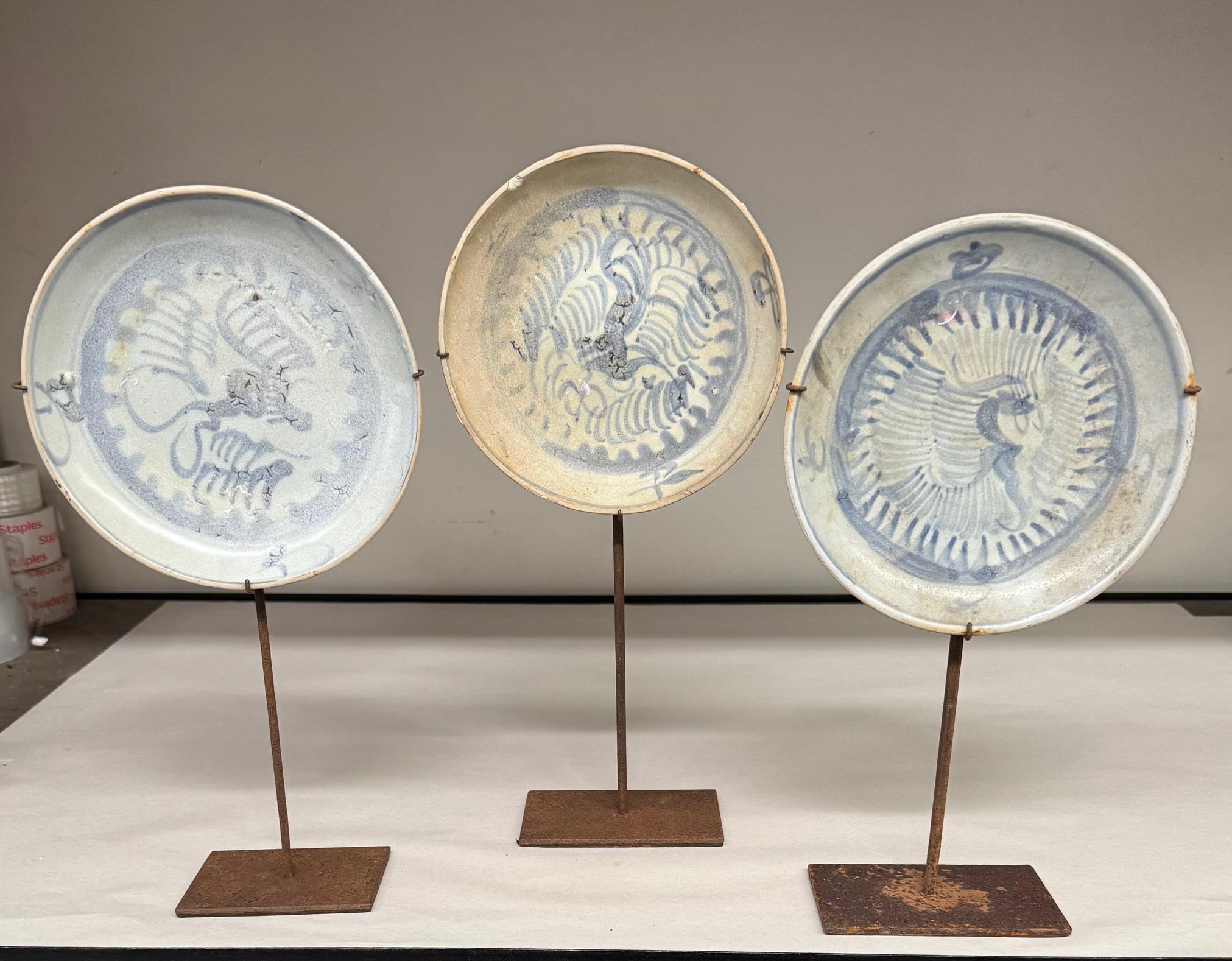 16th century Chinese Ming Dynasty set of three hand painted plates on stands.
Plate sizes.   7 x. 14.5         7. x. 14.   7. x. 13.5
Stands measure.  5. x. 3.  and.  4. x. 3