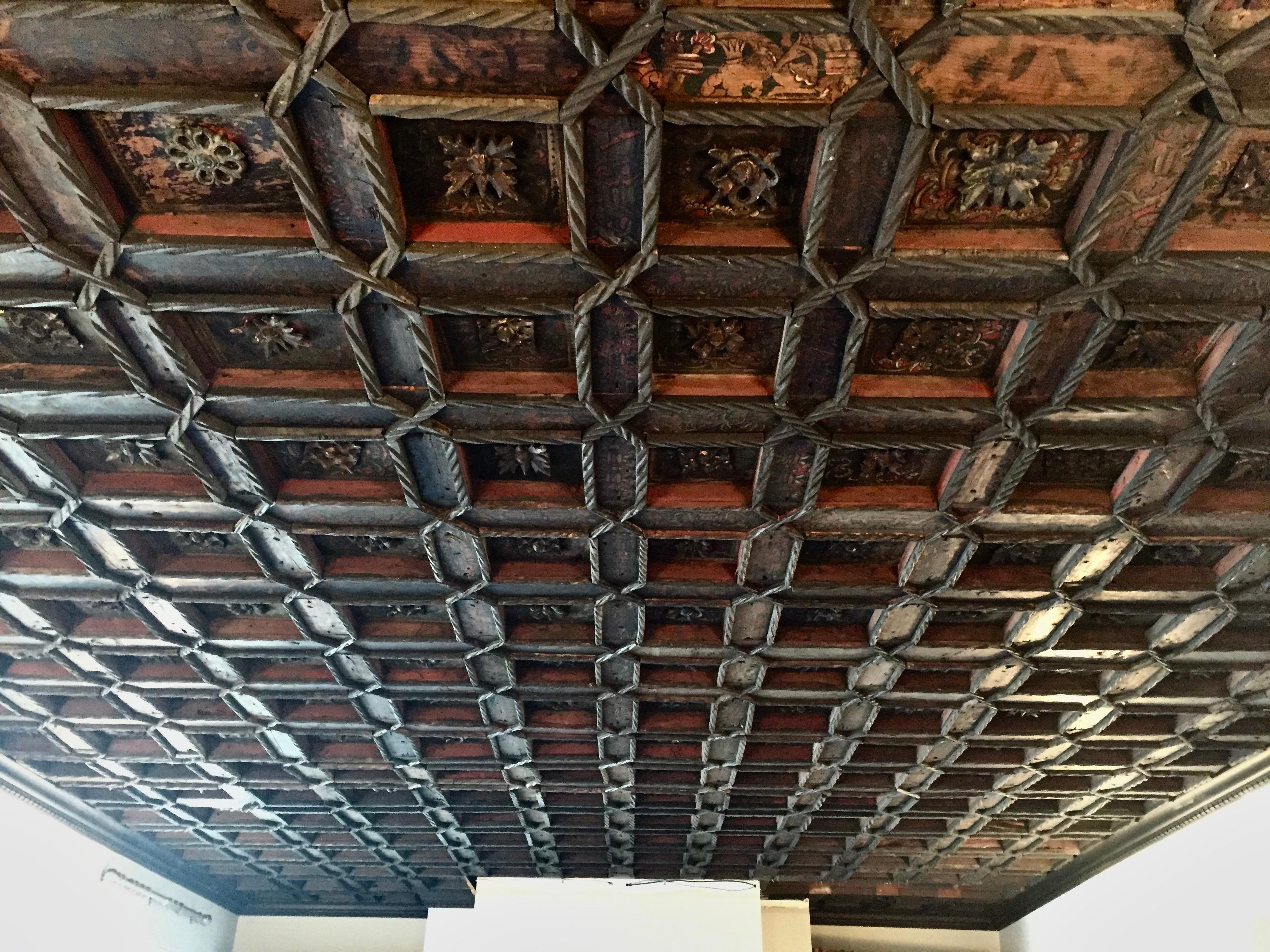 16th Century Spanish Renaissance Coffered Ceiling.  Tempura on Pine is brilliant colors of azure, red, black and white.  Moorish Rosettes and intertwined motifs throughout.  Was reduced from a much larger ceiling and removed by us from an historic