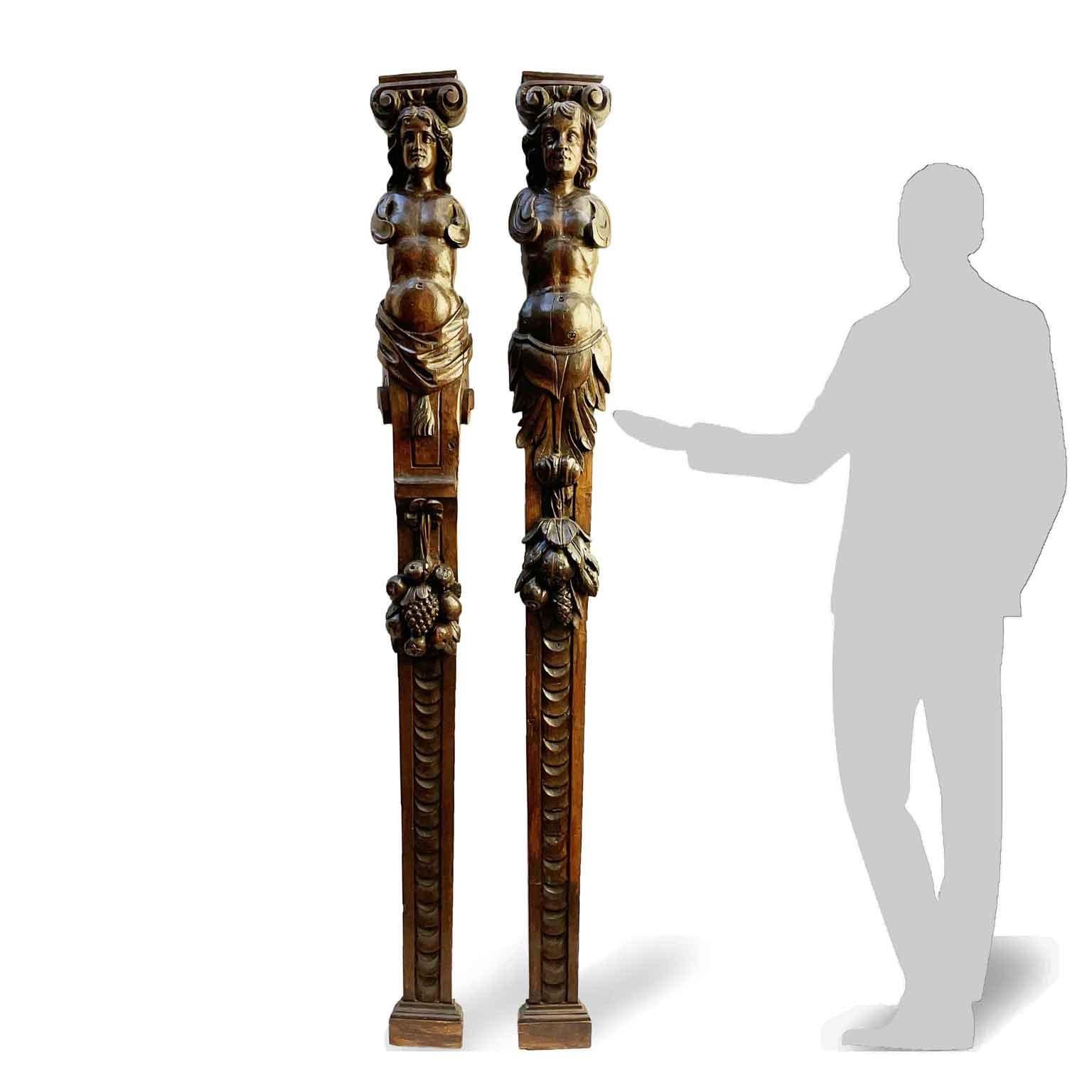 Unique pair of Italian hand-carved caryatids, dating back to 1500 circa, almost 83 inches 210cm high, this antique pair of dark patina Renaissance sculptures comes from a choral ensemble, used as partitions between the stalls. The two bas-relief
