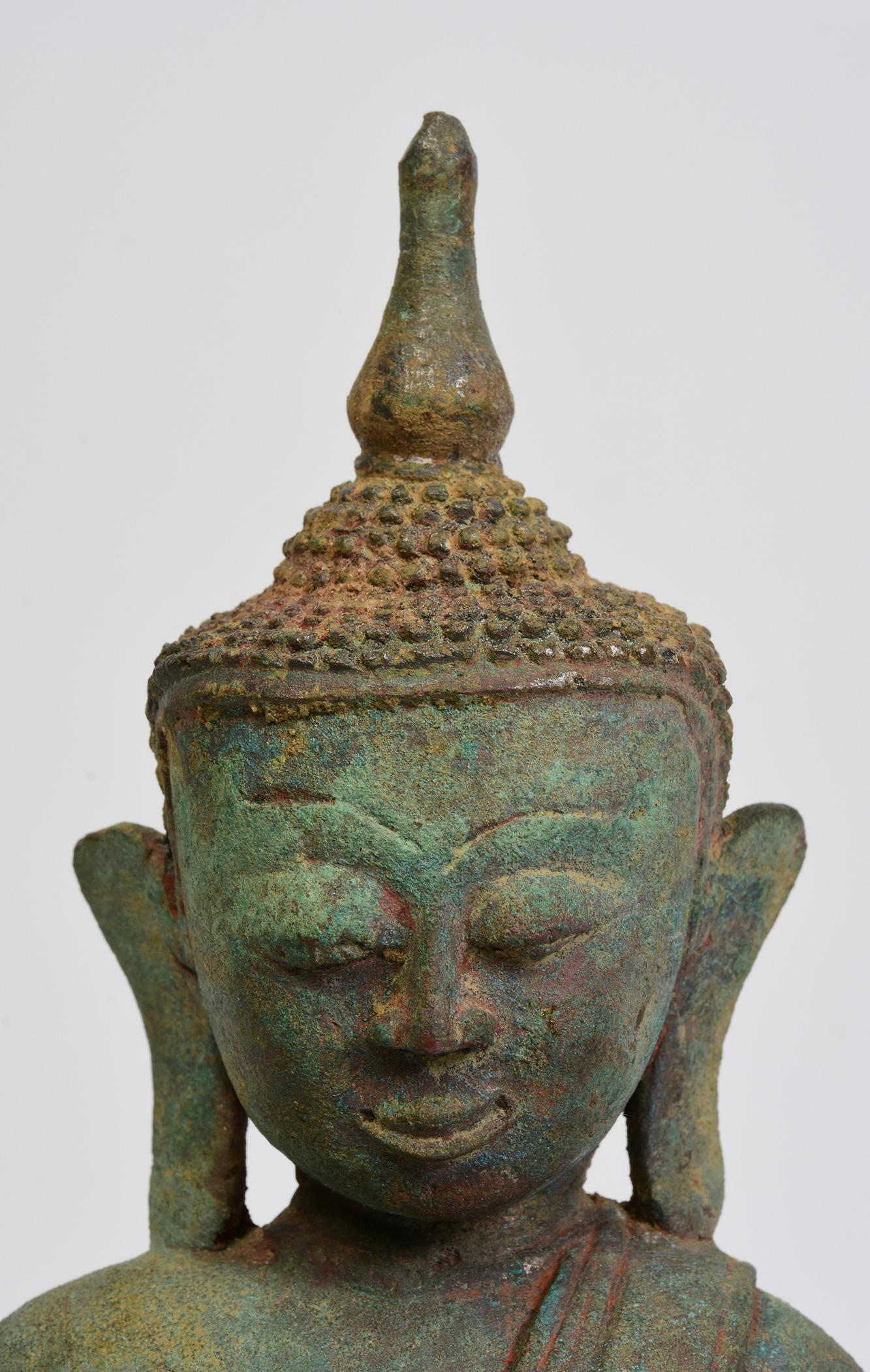 Antique Burmese bronze Buddha sitting in Mara Vijaya (calling the earth to witness) posture on double lotus base with excellent green patina.

Age: Burma, Shan Period, 16th Century
Size: Height 29.5 C.M. / Width 16.8 C.M. / Depth 12 C.M.
Condition: