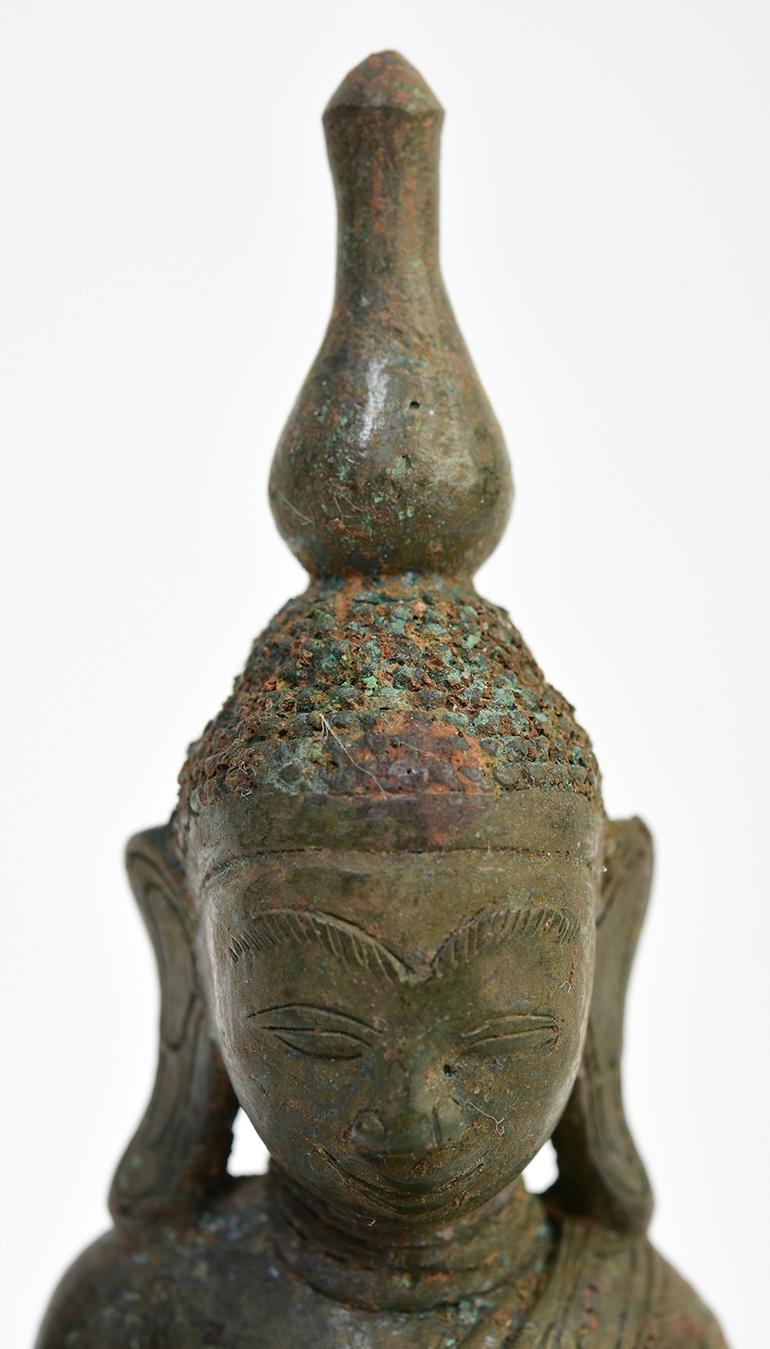 Burmese bronze Buddha sitting in Mara Vijaya (calling the earth to witness) posture on a base.

Age: Burma, Shan Period, 16th Century
Size: Height 16.3 C.M. / Width 8.6 C.M.
Condition: Nice condition overall.

100% Satisfaction and Authenticity