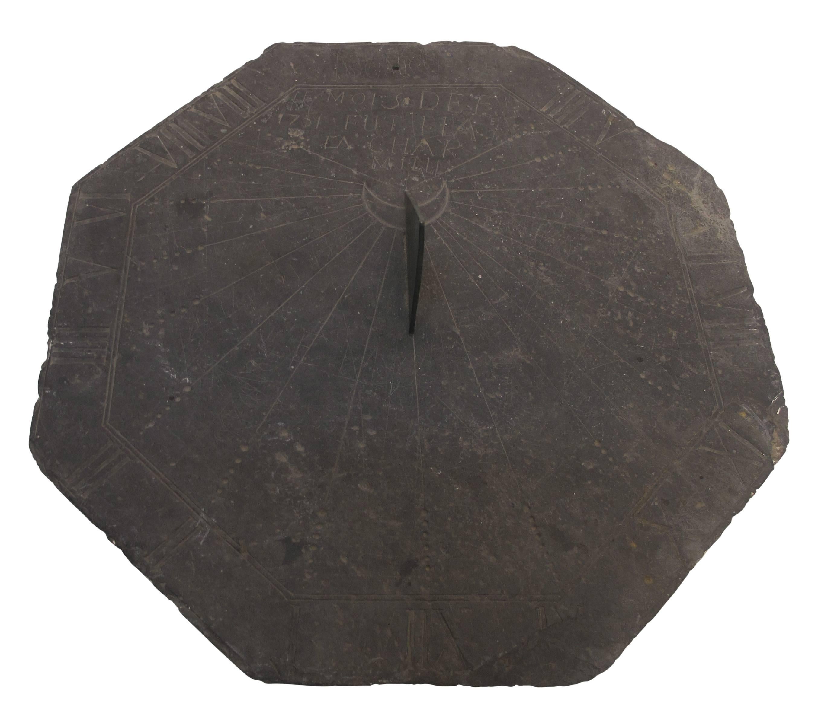 A 16th century slate stone sundial with bronze gnomon (the gnomon is not original).