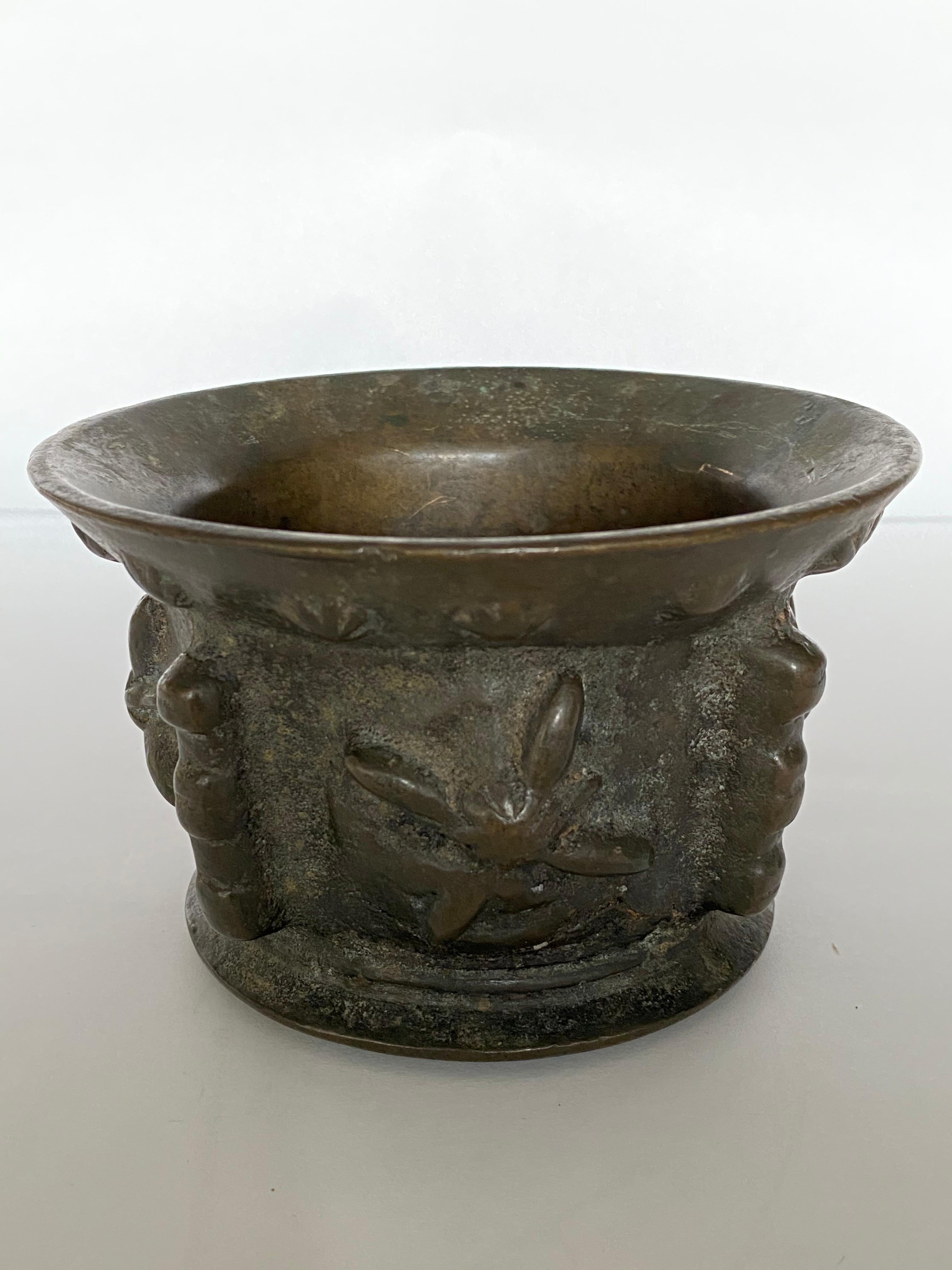 This rare example of a Renaissance bronze mortar is decorated with starbursts all along the everted rim and features 4 large starbursts on the sides between the ribbed handles. The convex bottom indicates active use, most likely in a pharmacy or by