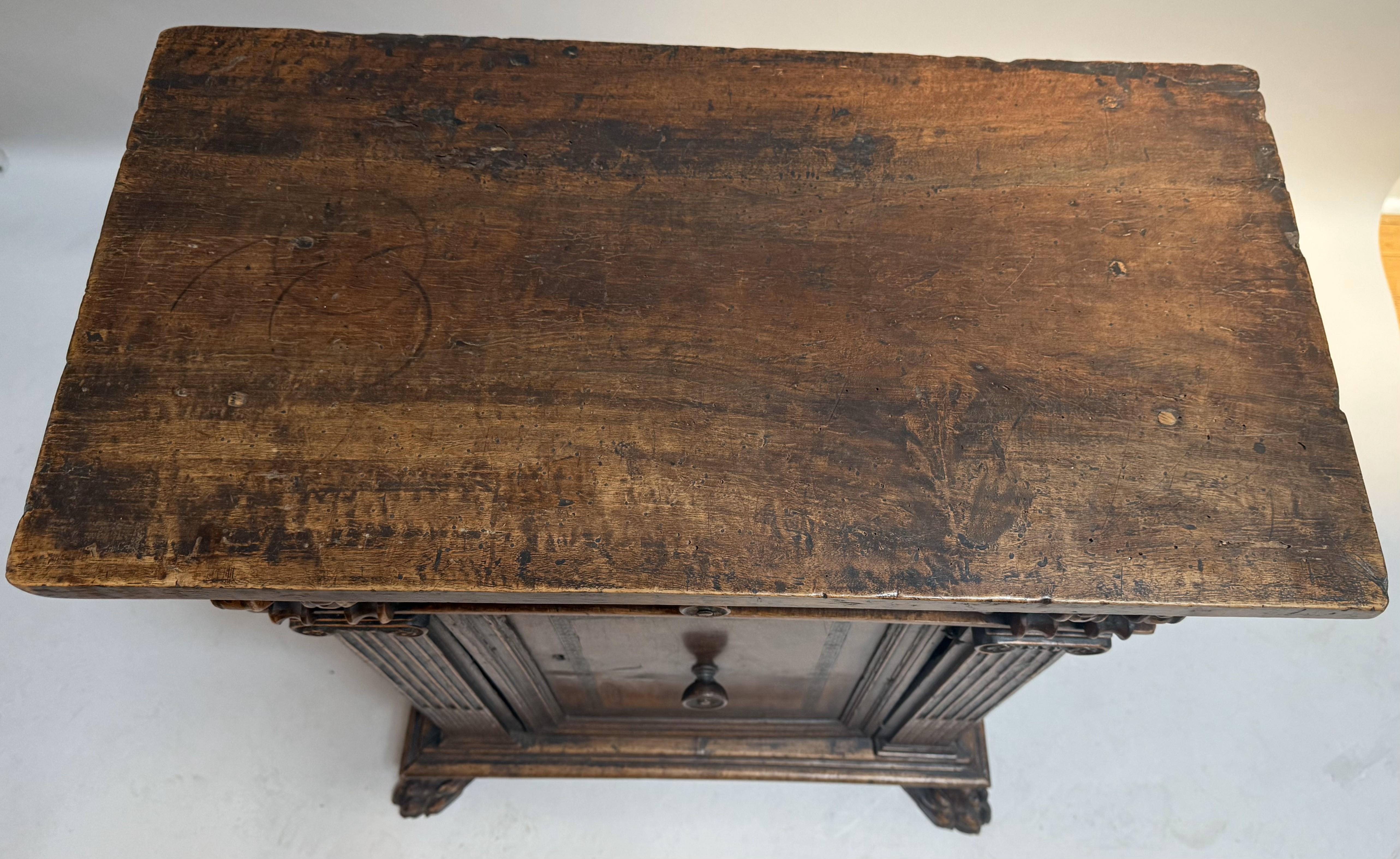 An exceptional late Renaissance Italian credenza, hand-crafted in Tuscany circa 1570 from richly grained Circassian walnut. This singular piece exudes Old World grandeur through its robust architectural form, intricate detailing, and masterful