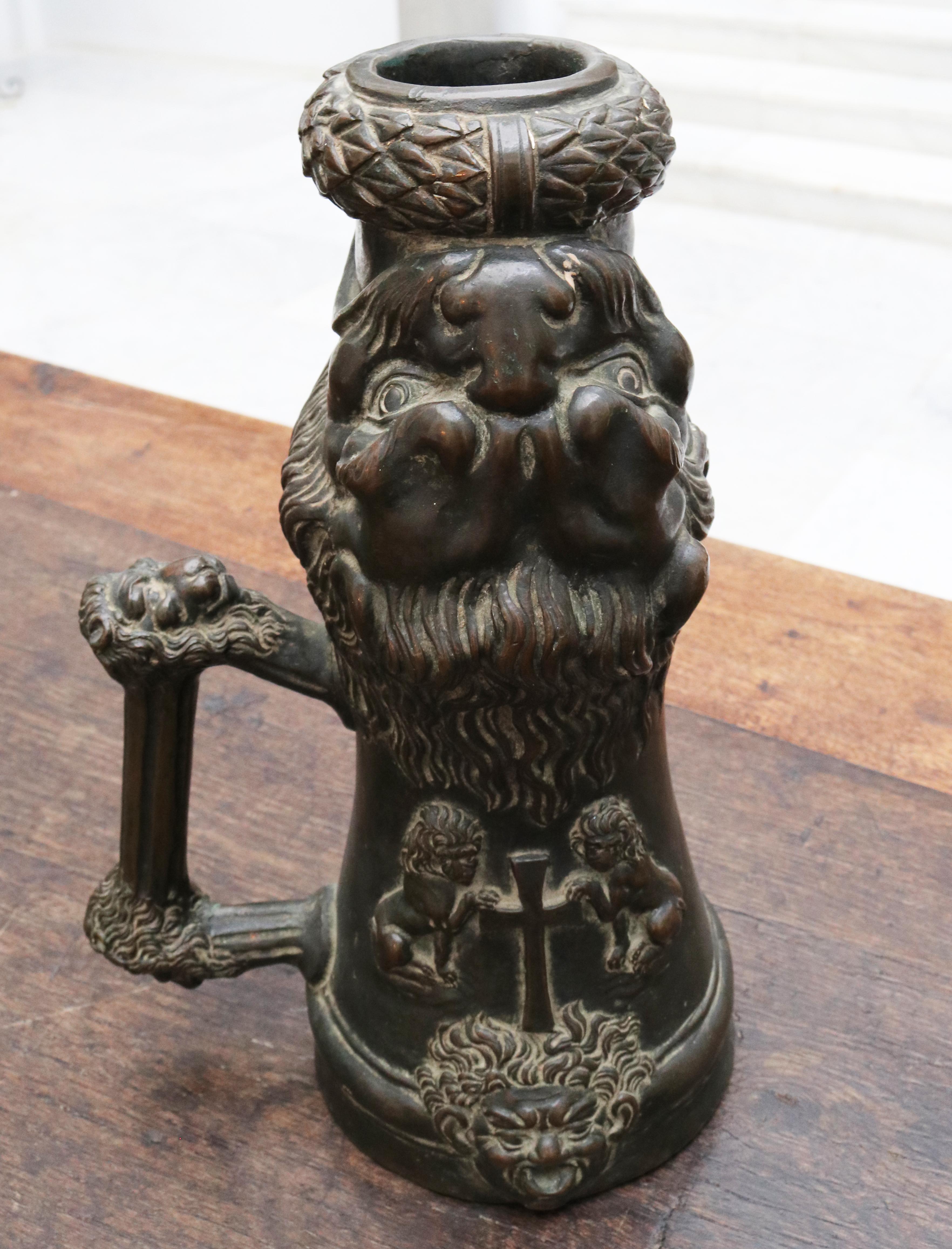 16th century Venetian palace fireworks bronze cannon profusely decorated in high relief. The cannon mouth is a laurel leaf crown and a large lion head. Two sitting lions next to the cross above a head on the base whose mouth hides the hole for the