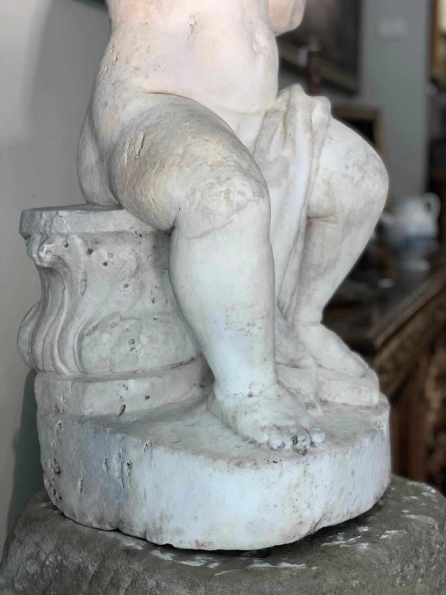 Splendid white Carrara marble sculpture depicting young Hercules supporting the world. The work was created to be used as a caryatid at the beginning of a marble staircase of some building, then sold and in the 1900s it was part of a collection in a