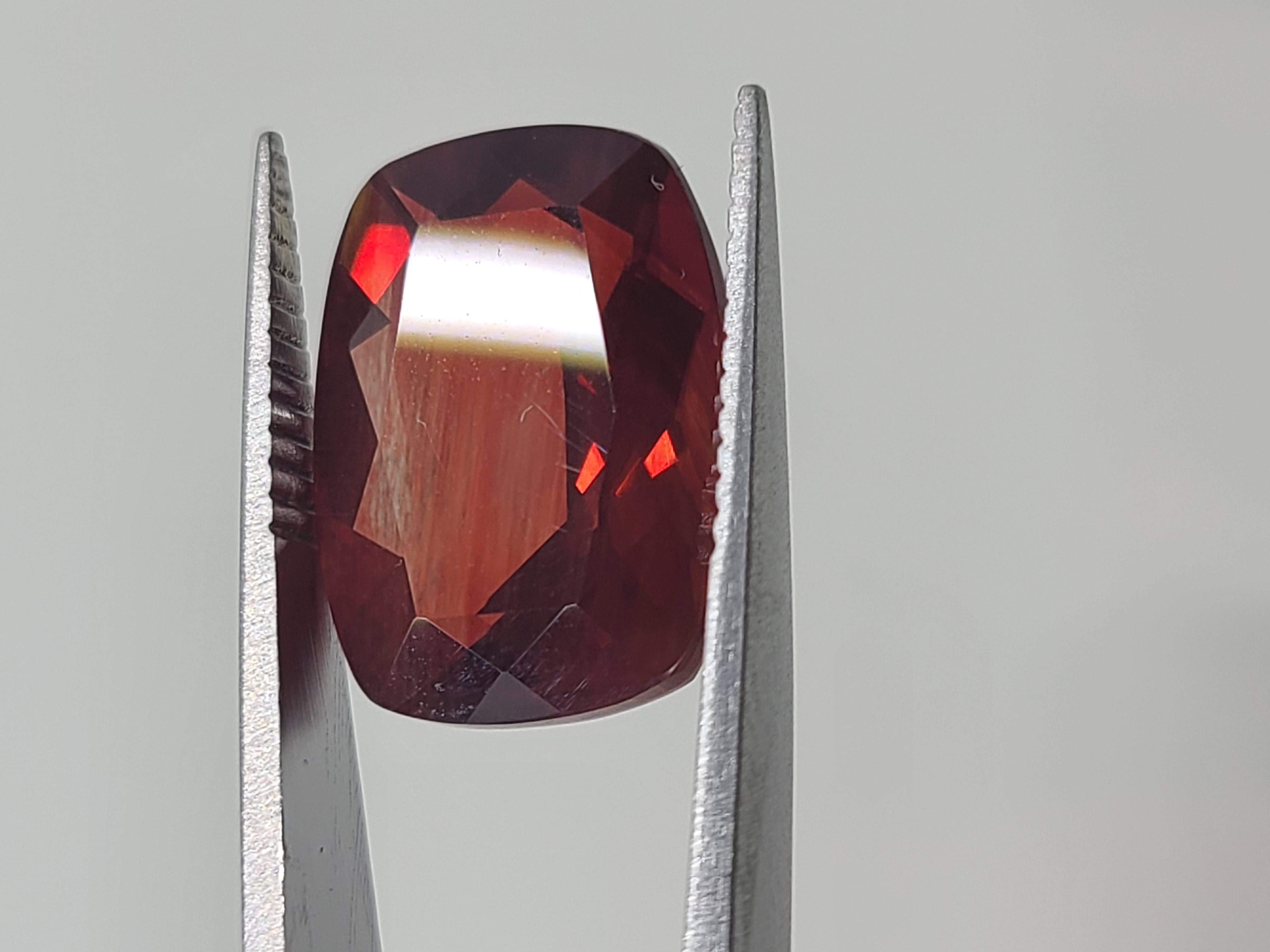 This Red Andesine Labradorite comes from the estate of a private collector. It's emerald cut measuring 16x12mm with a 7.4mm depth and weighs 9.14 carats. It is a wonderful shade of brilliant red.