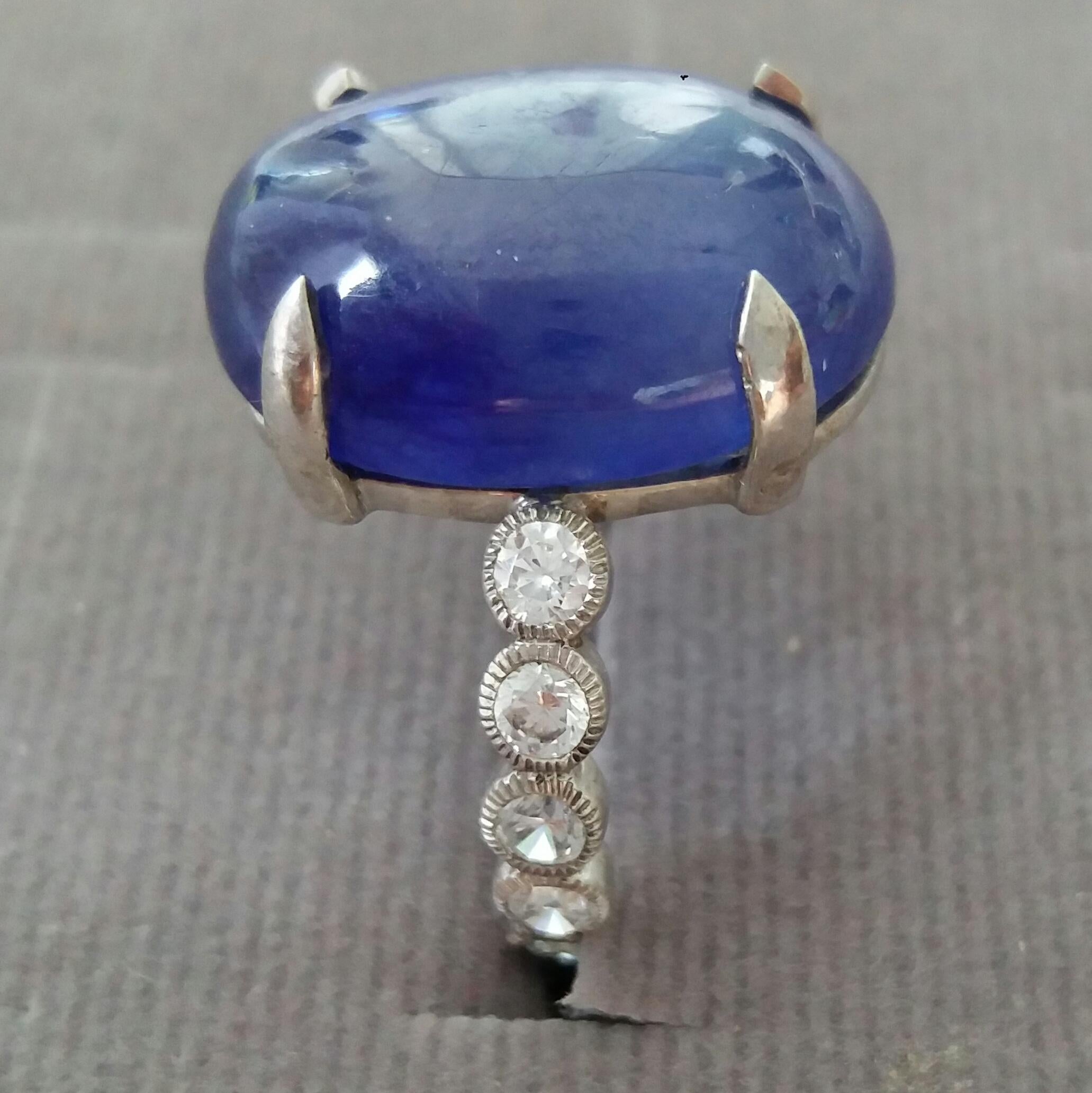 17 Carat Blue Sapphire Oval Cab ring ( 17,5 mm x 13 mm )  set with 3,3 grams of 14 kt white gold. 12 round full cut diamonds of 0,05 ct. each = 0,6 ct total diamonds weight
Ring Shank Diameter  23 mm
Height 25 mm
Weight 6 grams
In 1978 our workshop