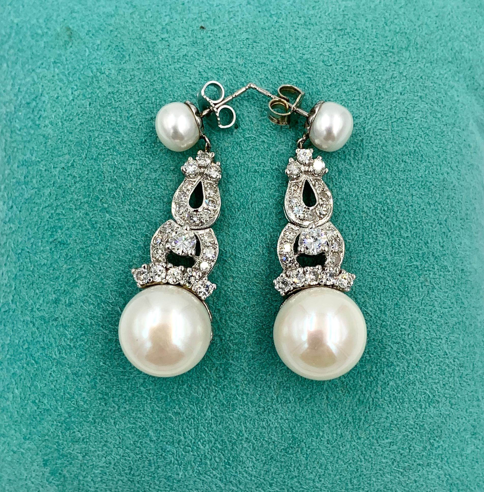 A stunning pair of Art Deco - Hollywood Regency style Earrings.  The earrings are set with 44 radiant white Diamonds which total 1.7 Carats.  The earrings have gorgeous 13mm white Pearls at the bottom and they hang from 7mm Pearls at the top.  The