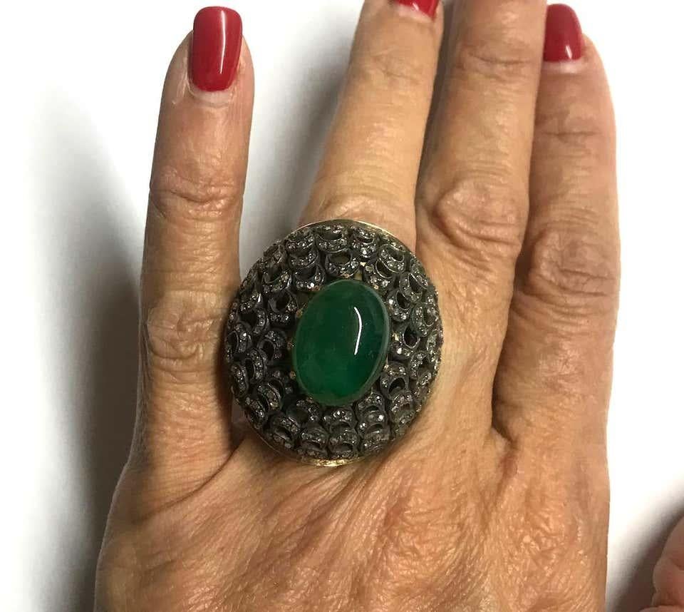 Edwardian style, Diopside Oval shaped cabochon with rose cut diamonds, set in a Bubble ring.  The rich deep color green is desirable.
The ring measures 39 x 33 x 21.53 height, a very large, very unusual ring often seen in the Hollywood Era. The