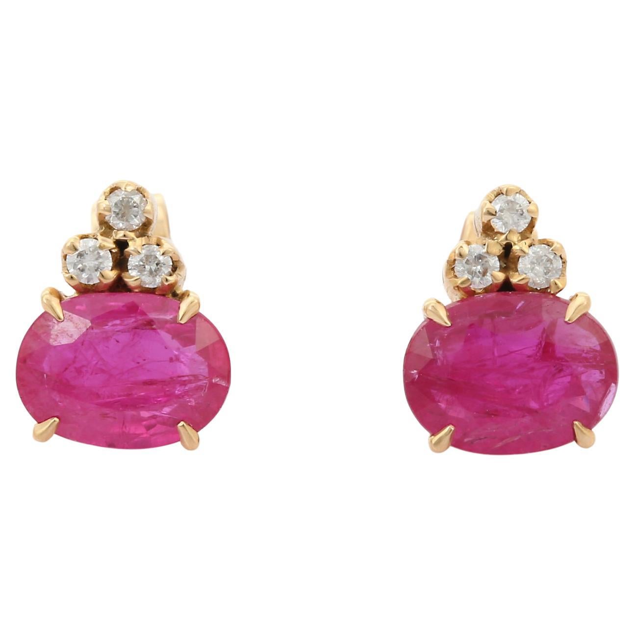 1.7 Ct Oval Cut Ruby Stud Earrings with Diamonds Studded in 18K Yellow Gold