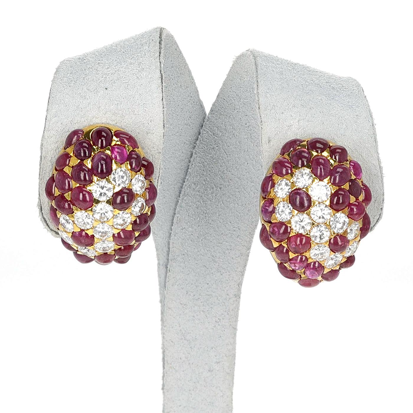 A pair of Ruby Cabochon and Round Diamond Cluster Earrings made in 18 Karat Yellow Gold. The total weight of the earrings is 15.20 grams.  The length of the earring is 1 inch. 