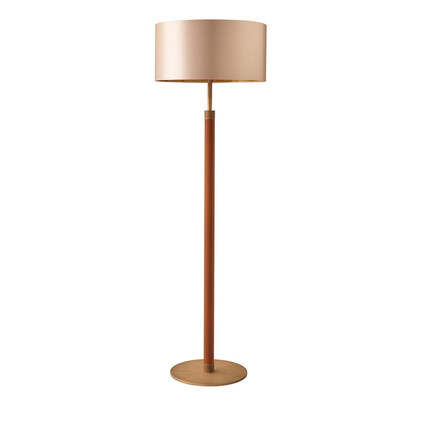 A timeless floor lamp in brass and leather, topped with a silk-effect shade. The 1.7 floor lamp is characterized by a clean but cozy look thanks the use of brass with a burnished finish and cognac leather, making it perfect for warming up Minimalist