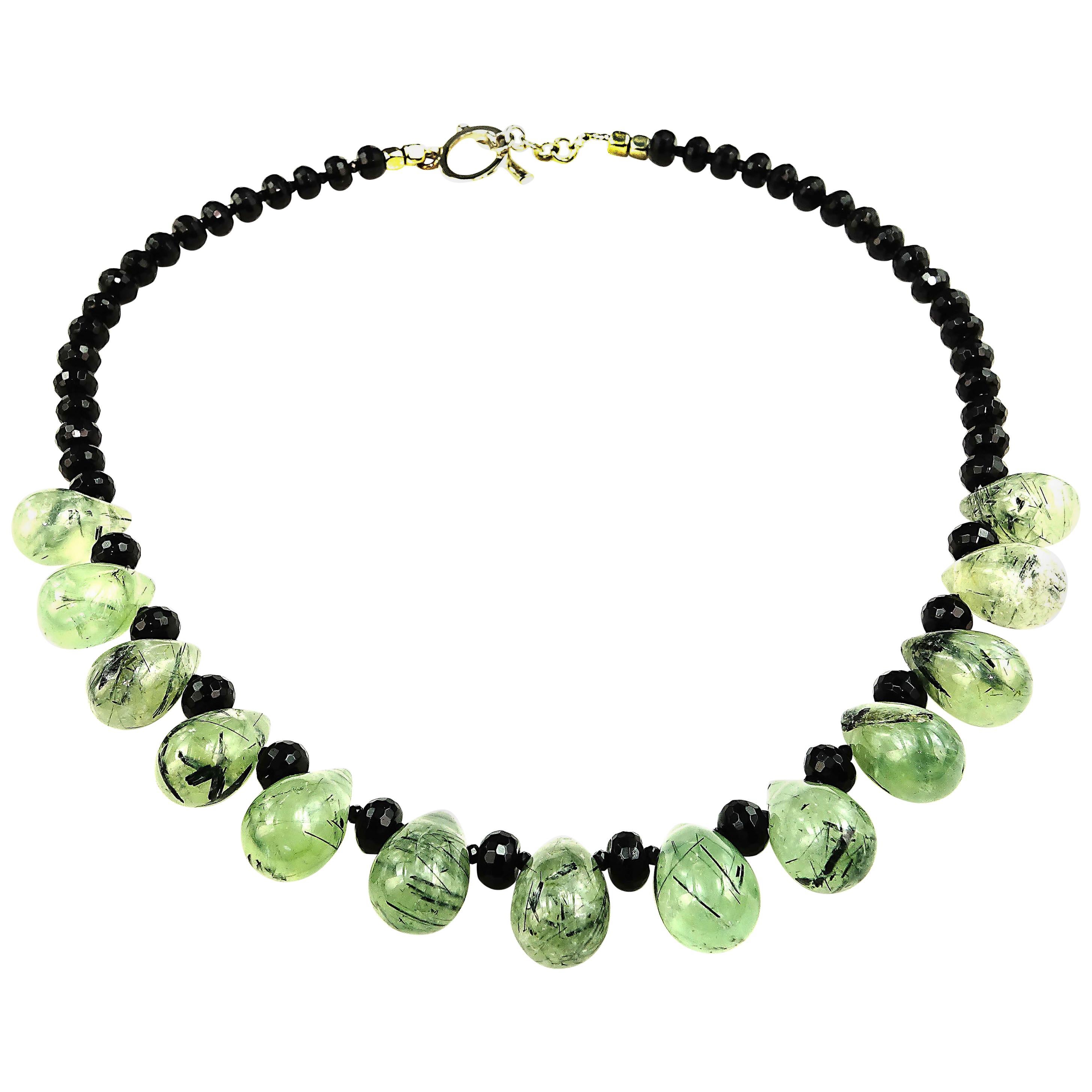 17 Inch unique necklace of smooth green Prehnite  briolettes and faceted black Onyx rondelles.  These gorgeous Prehnite briolettes come straight from one of our favorite suppliers in Sao Paulo. They have such interesting black inclusions accented by