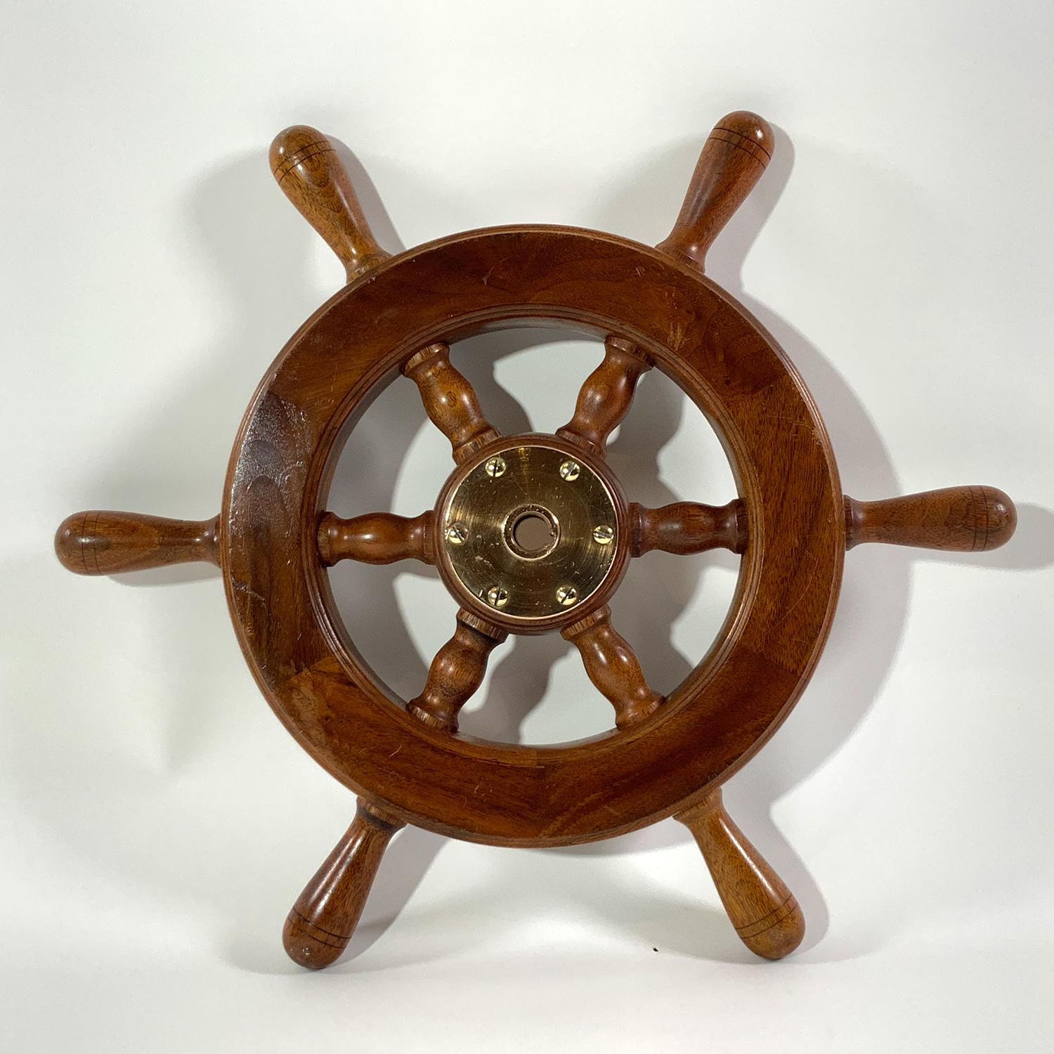 Ships wheel with six turned spindles, brass hub with keyhole. Seventeen inch diameter. Circa 1950.