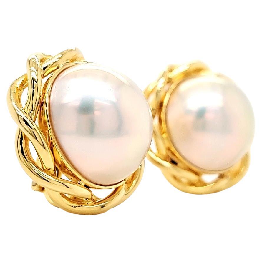17 mm Mabe Pearl and 18 K earrings.

They are bright, with clean surfaces , and an attractive looking pair that took 3 years to grow on the shell of the mollusk in the depths of the French Polynesian Islands.

Once worn, or even on the dressing