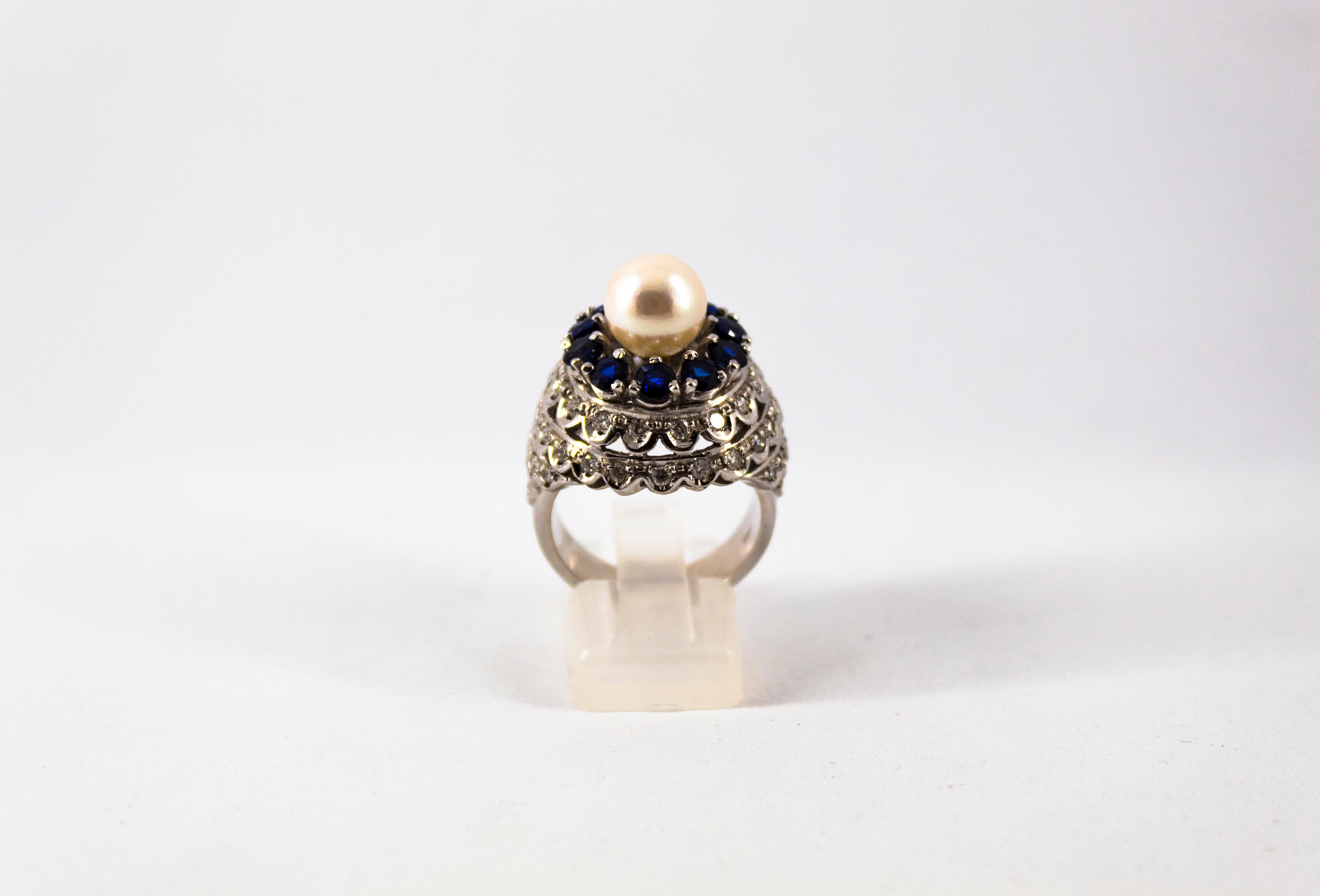 This Ring is made of 18K White Gold.
This Ring has 1.30 Carats of White Diamonds.
This Ring has 1.70 Carats of Blue Sapphires.
This Ring has also a Pearl.
Size ITA: 15 USA: 7 1/4
We're a workshop so every piece is handmade, customizable and