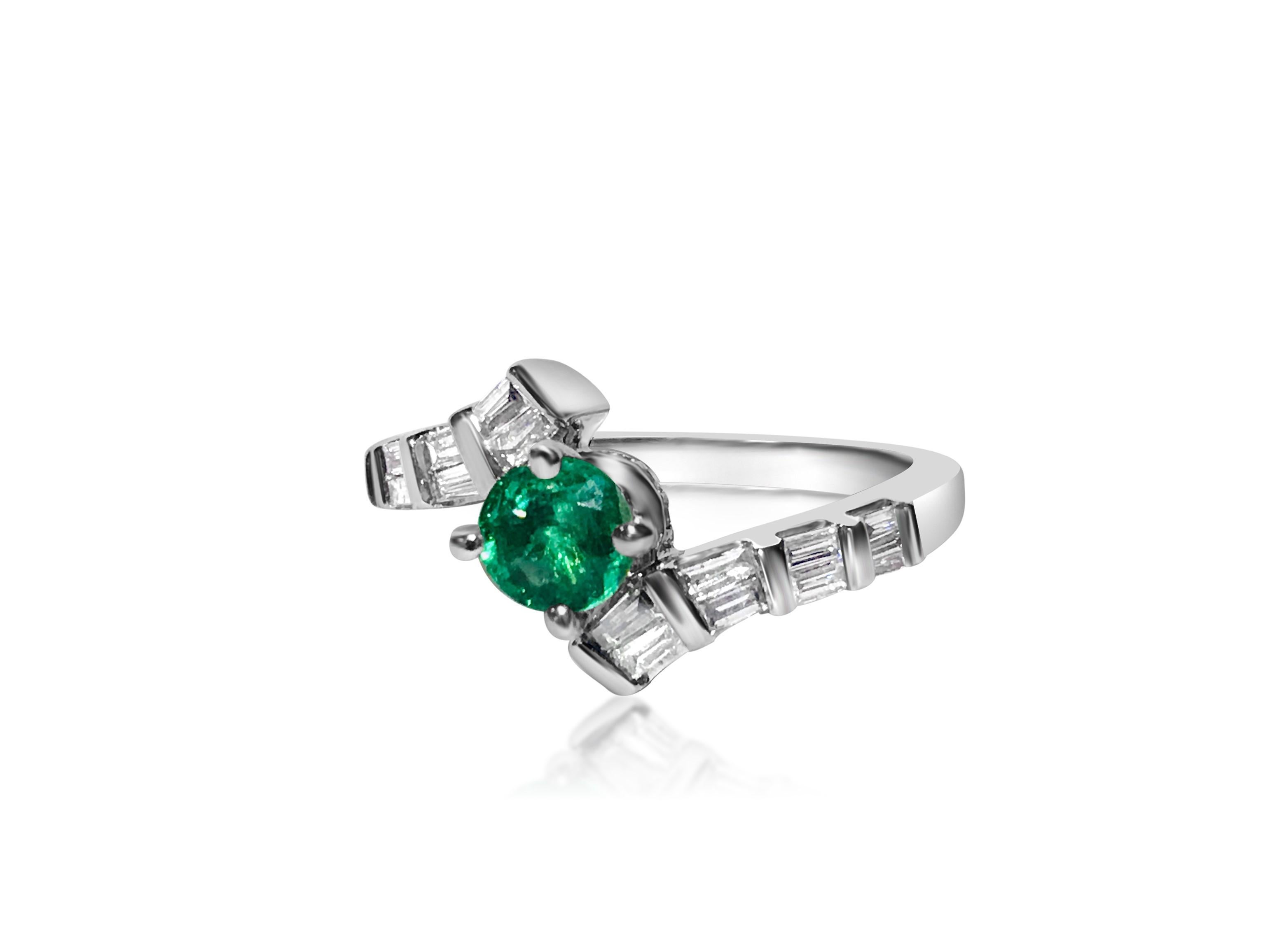 Metal: 14K white gold.
1.00 carat diamonds total. VS clarity and G color. Baguette cut diamonds. 
0.70 carat Colombian Emerald, round cut. All stones are 100% natural earth mined. 
TCW of all stones: 1.70 carat. 
Art Deco style emerald diamond