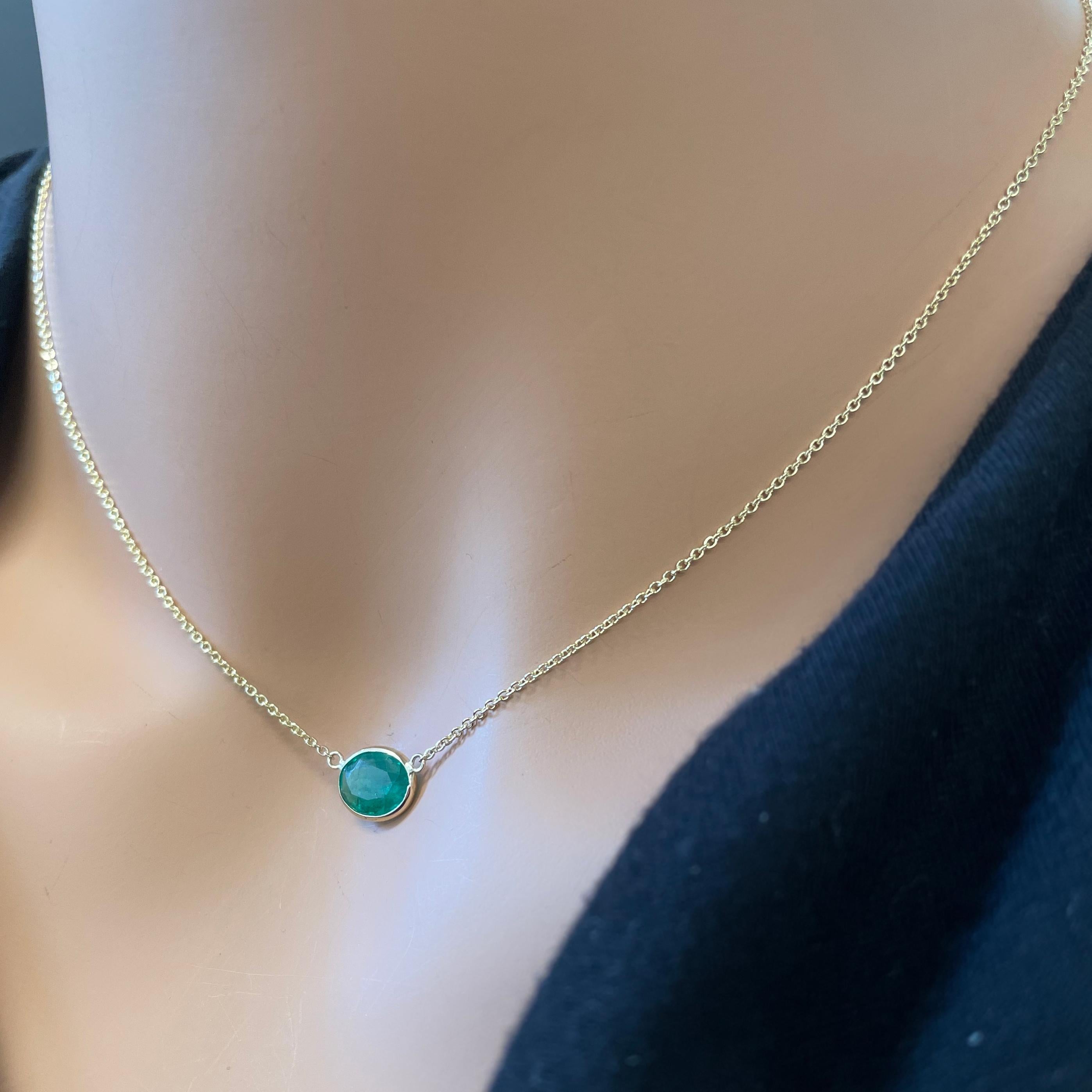 This necklace features an oval-cut green emerald with a weight of 1.70 carats, set in 14k yellow gold (YG). Emeralds are renowned for their vibrant green color, and the oval cut is a classic and elegant choice for gemstones, offering a timeless and