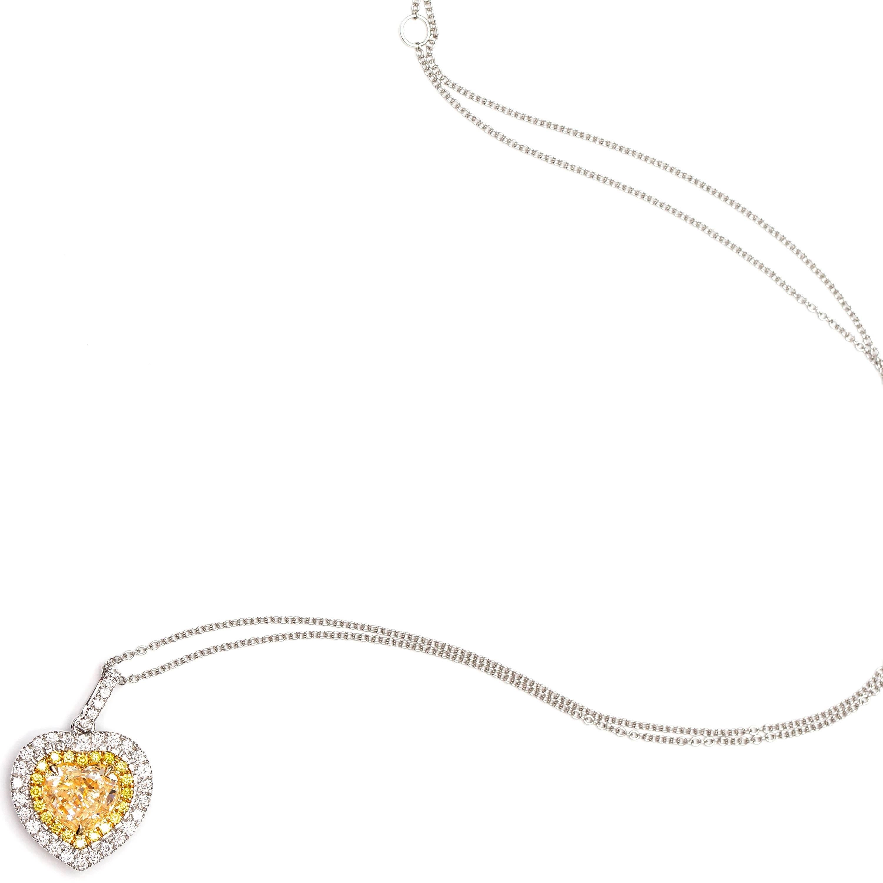 A Gorgeous 1.44 Carat Yellow Heart Shaped claw set Pendant. Heart Surrounded by a double halo of beautiful contrasting Yellow and White Brilliant Round Diamonds weighing a total of 0.26 Carat. Set in 18 Karat White Gold. A beautiful pendant that can