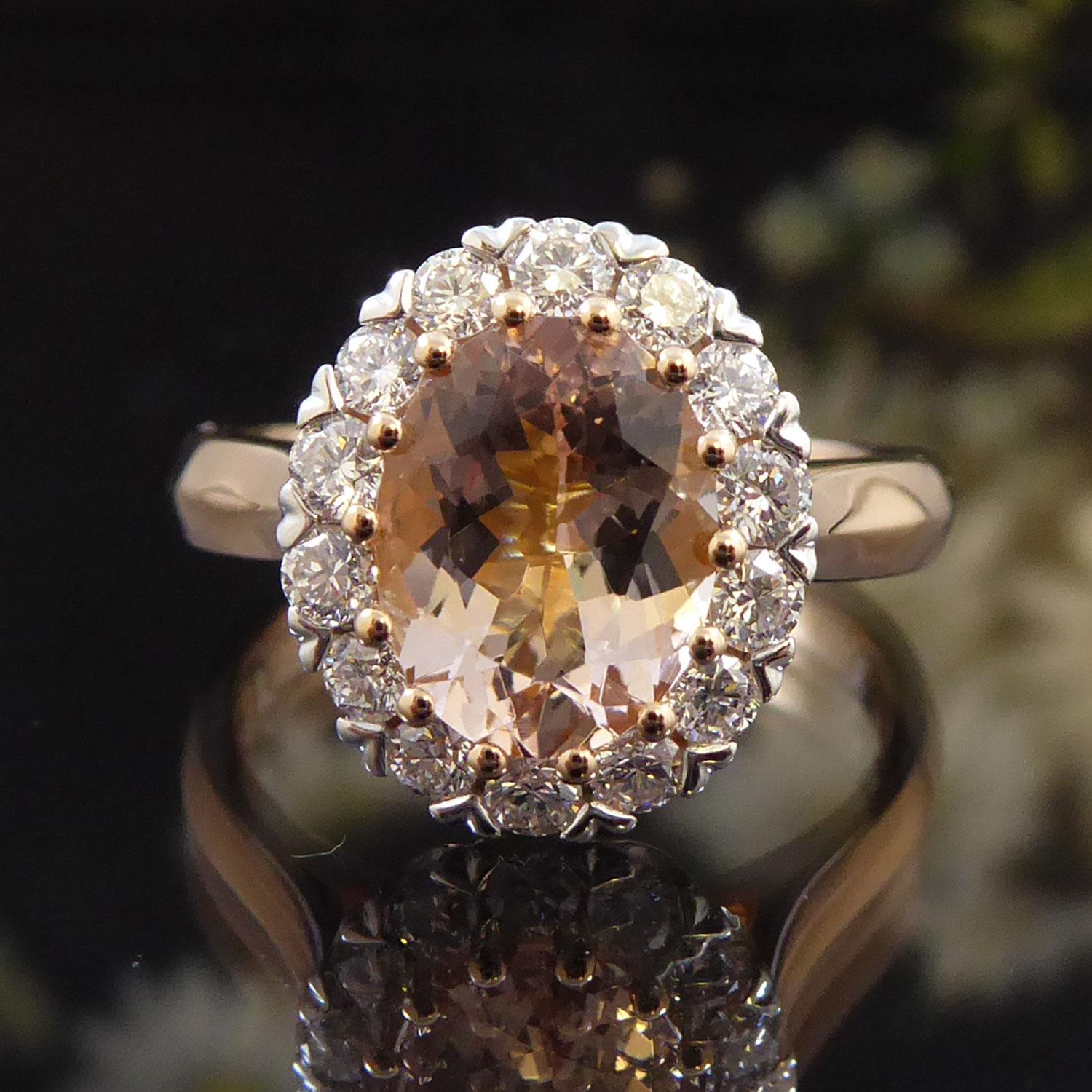 A beautiful faceted oval morganite of pale-pink colour in rose gold claw settings to a halo of brilliant cut diamonds in white, V-shaped mounts.  The morganite weighs 1.70ct.  The diamonds weight 0.50ct in total and have colour and clarity assessed