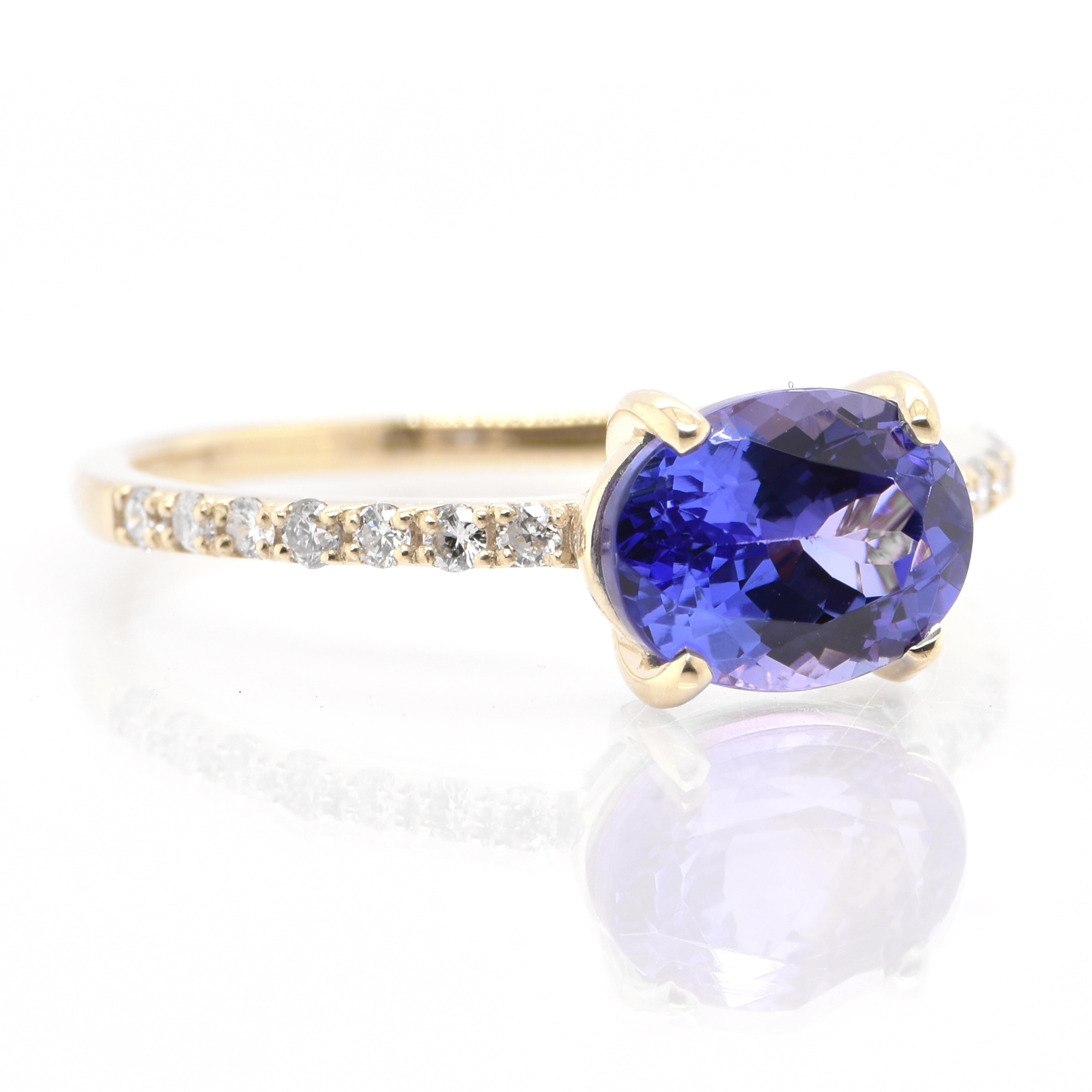A beautiful Engagement Ring featuring a 1.70 Carat Natural Tanzanite and 0.14 Carats of Diamond Accents set in 18 Karat Yellow Gold. Tanzanite's name was given by Tiffany and Co after its only known source: Tanzania. Tanzanite displays beautiful