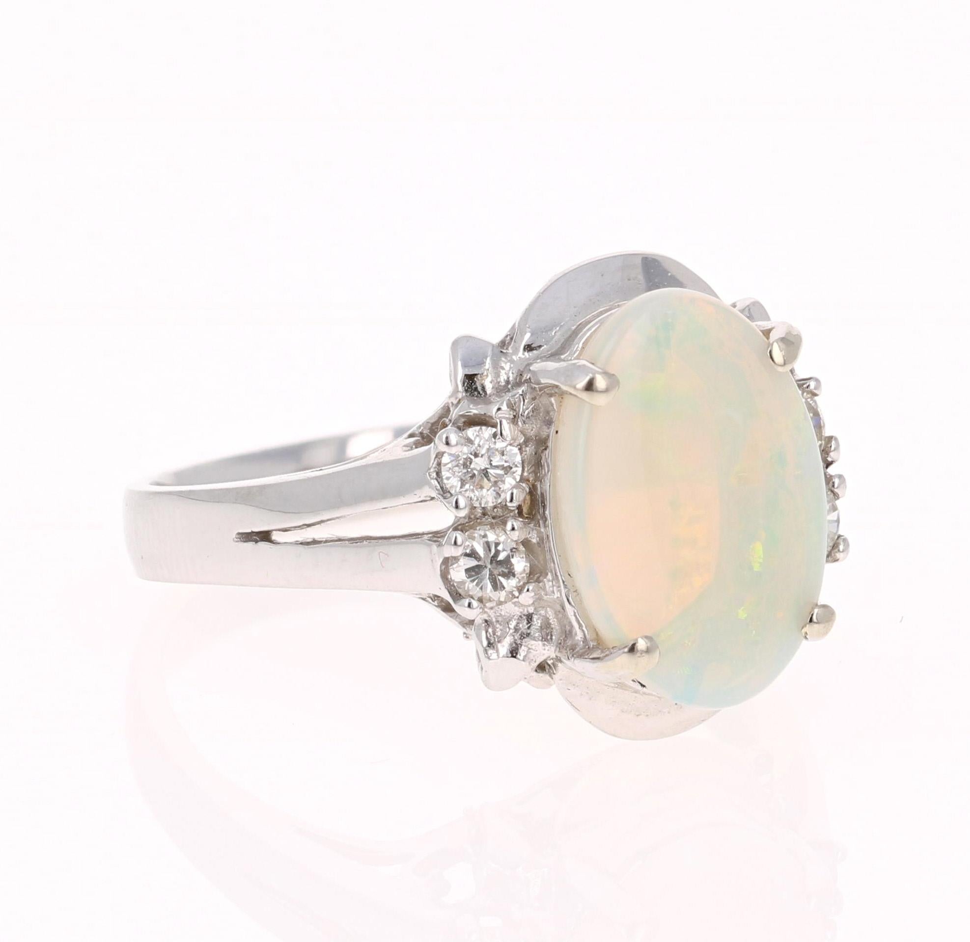 This ring has a cute and simple 1.51 Carat Opal and has 4 Round Cut Diamonds that weigh 0.19 Carats. The total carat weight of the ring is 1.70 Carats. 

The Opal displays beautiful flashes of green, yellow, and orange and has its origins from