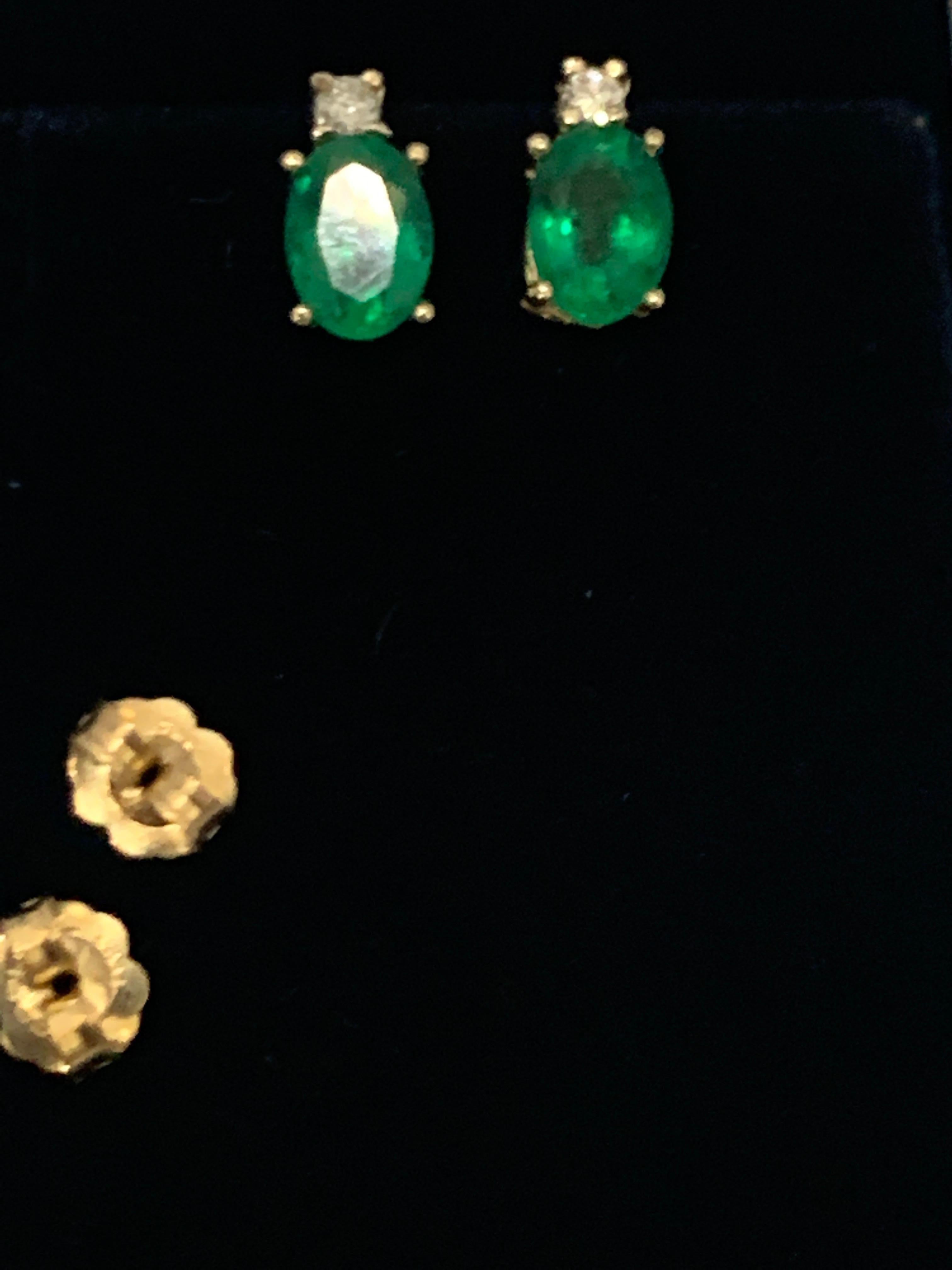 
1.70 Carat 7 X 5 MM Oval Natural Emerald Stud Post Earrings 14 Karat Yellow Gold
Two emerald weighing approximately  1.7 carats Total
Each emerald is 0.85 Ct
Each stud has a tiny diamond on the top of the emerald.
Nice quality of emerald is used to