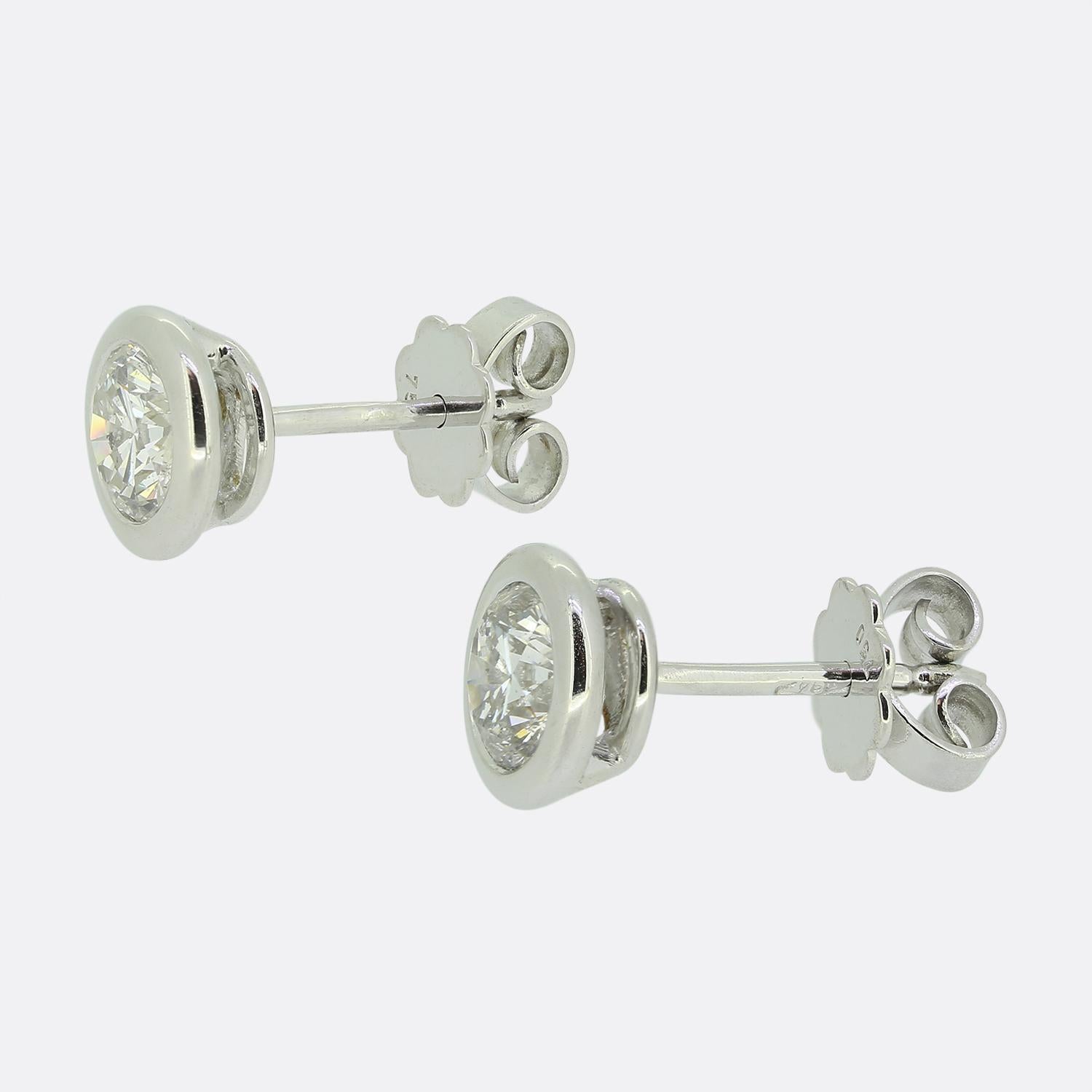 Here we have a classically styled pair of 18ct white gold diamond stud earrings. Each identical piece plays host to a single 0.85 carat round brilliant cut diamond in a neat rub-over setting.

Condition: Used (Very Good)
Weight: 2.9 grams
Total