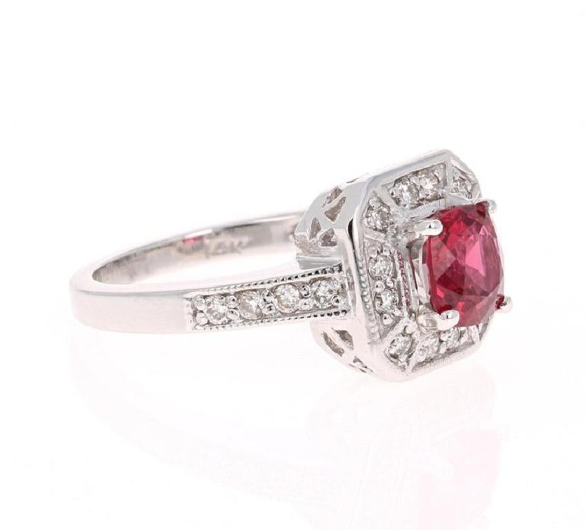 This Cushion Cut Red Spinel is natural and weighs 1.34 Carats and measures at 6.5 mm. It has 20 Round Cut Diamonds weighing 0.36 Carats. The clarity and color of the diamonds are SI-F.  The total carat weight is 1.70 Carats

It is set in 14K White