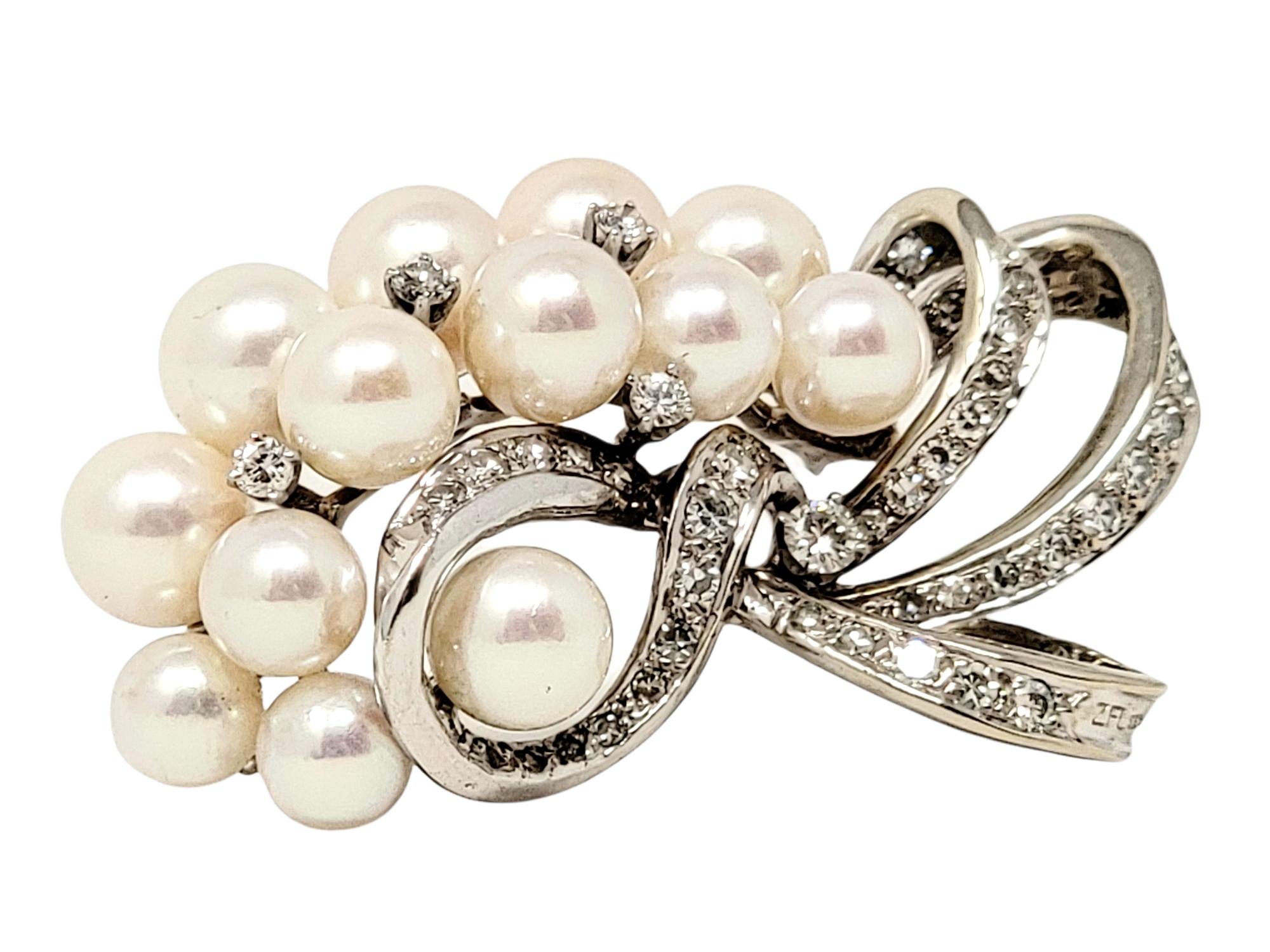 Exquisite vintage style brooch with incredible fine details. This gorgeous brooch is made of 14 karat white gold and arranged in a horizontal layout. The top portion features 2 rows of white cultured pearls, accented by a few single round diamonds.