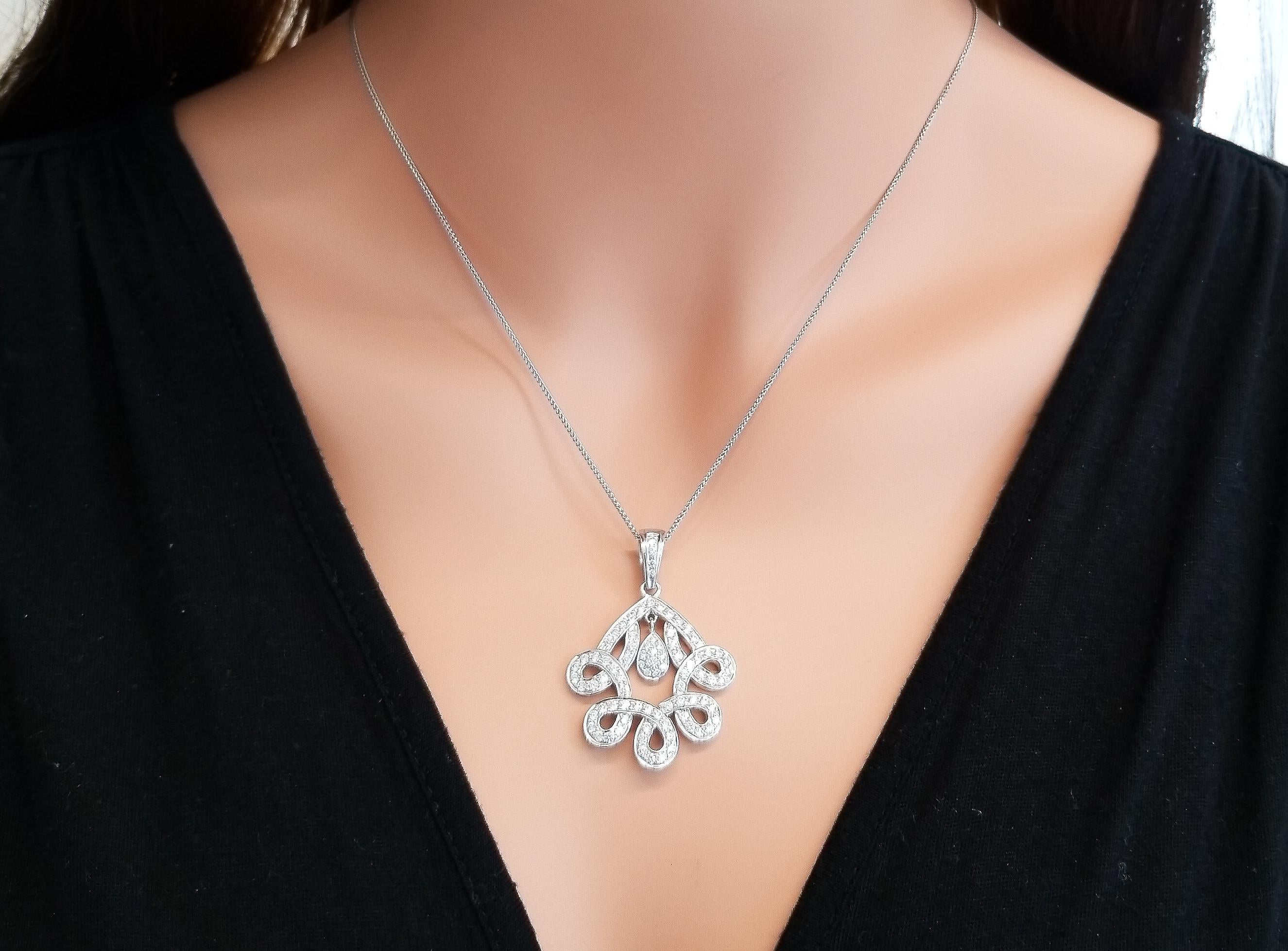 Dare to dazzle, with this spectacular Parisian inspired diamond pendant. This piece features an incredibly attractive and unique design that draws all eyes towards it. The pendant features 1.70 carat brilliant round diamonds that exhibit optimal