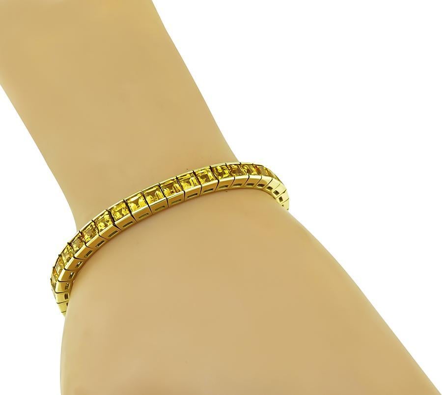 This is a charming 18k yellow gold bracelet. The bracelet is set with lovely square cut yellow sapphires that weigh approximately 17.00ct. The bracelet measures 7 inches in length and 5mm in width. The bracelet weighs 26.6 grams.