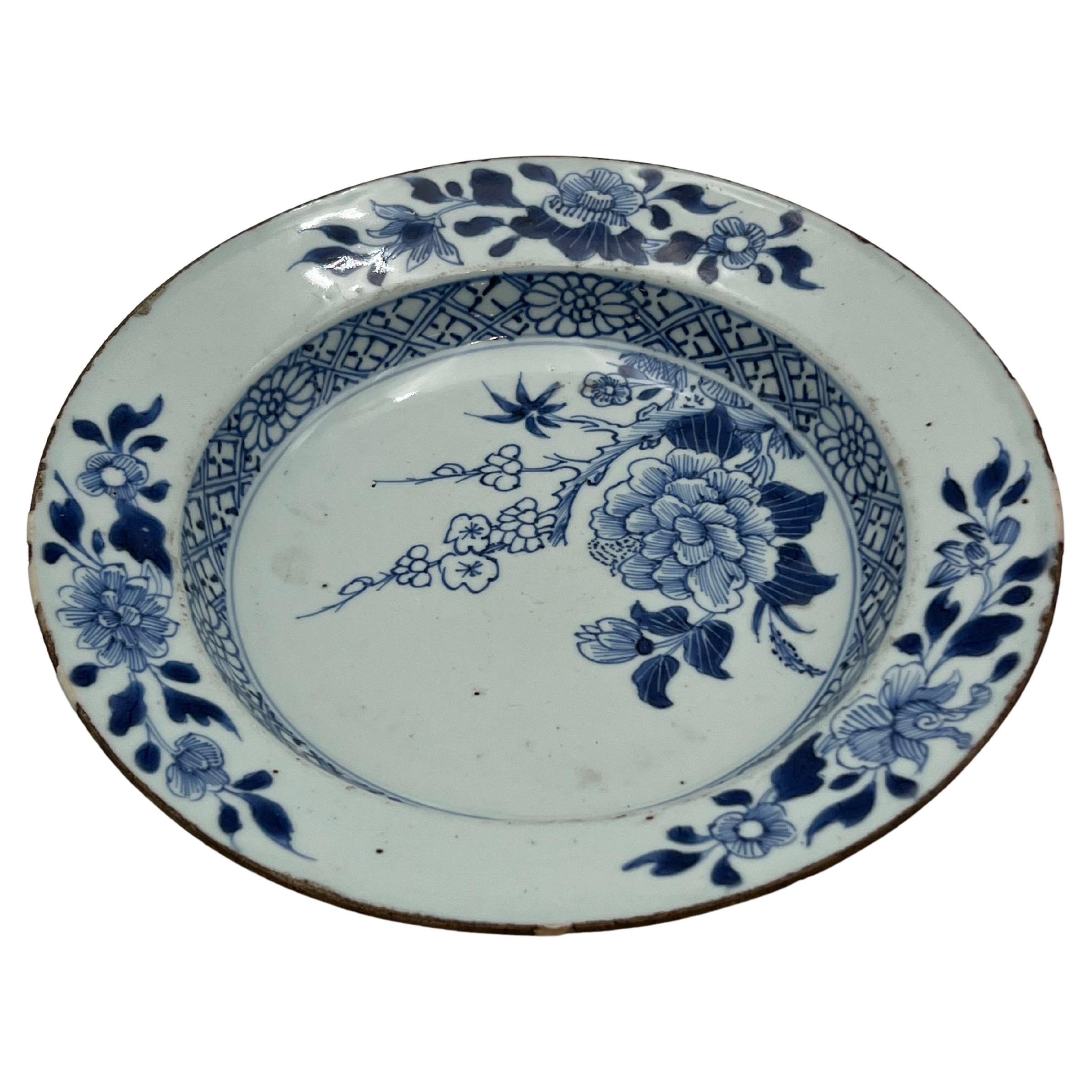 A stunning rustic antique blue and white porcelain plate, handcrafted in China during the early 1700s, featuring beautiful hand-painted underglazed decoration.

In good antique condition with the expected age-related wear. The porcelain shows some